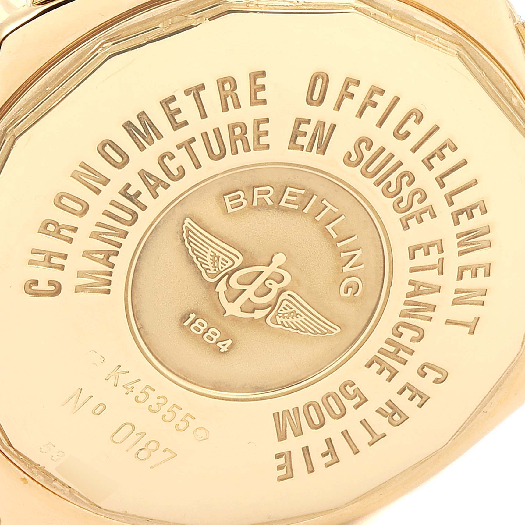 This image shows the back case of a Breitling Windrider K45355 Men's Yellow Gold Black Dial K45355 Men's Yellow Gold Black Dial watch with branding and specifications, including water resistance and serial number.