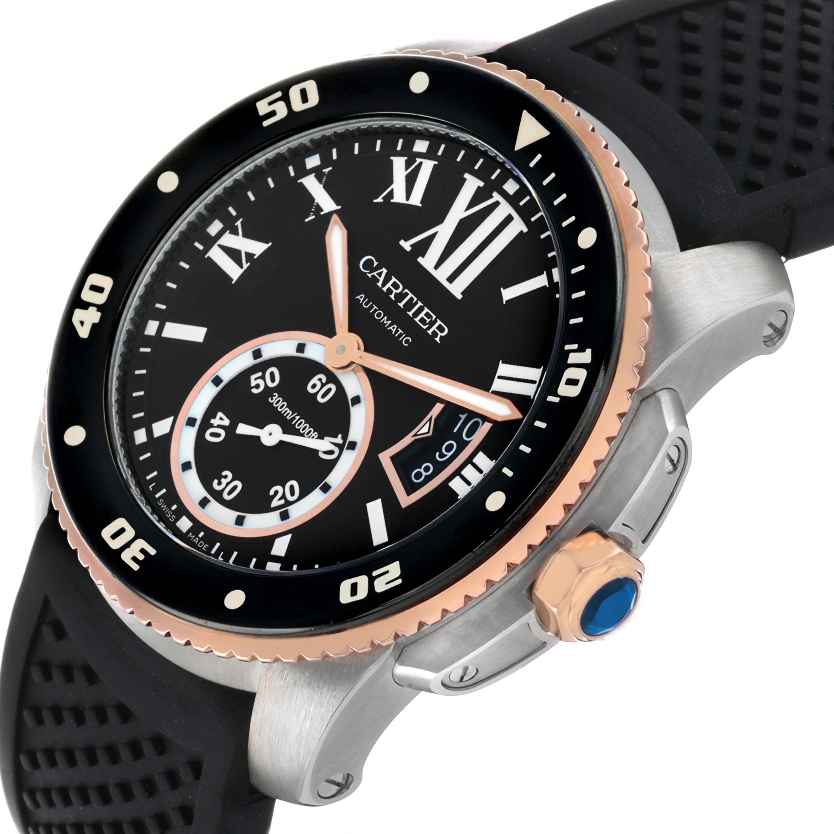 The Calibre de Cartier watch is shown at an angled side view, highlighting its bezel, crown, and rubber strap.