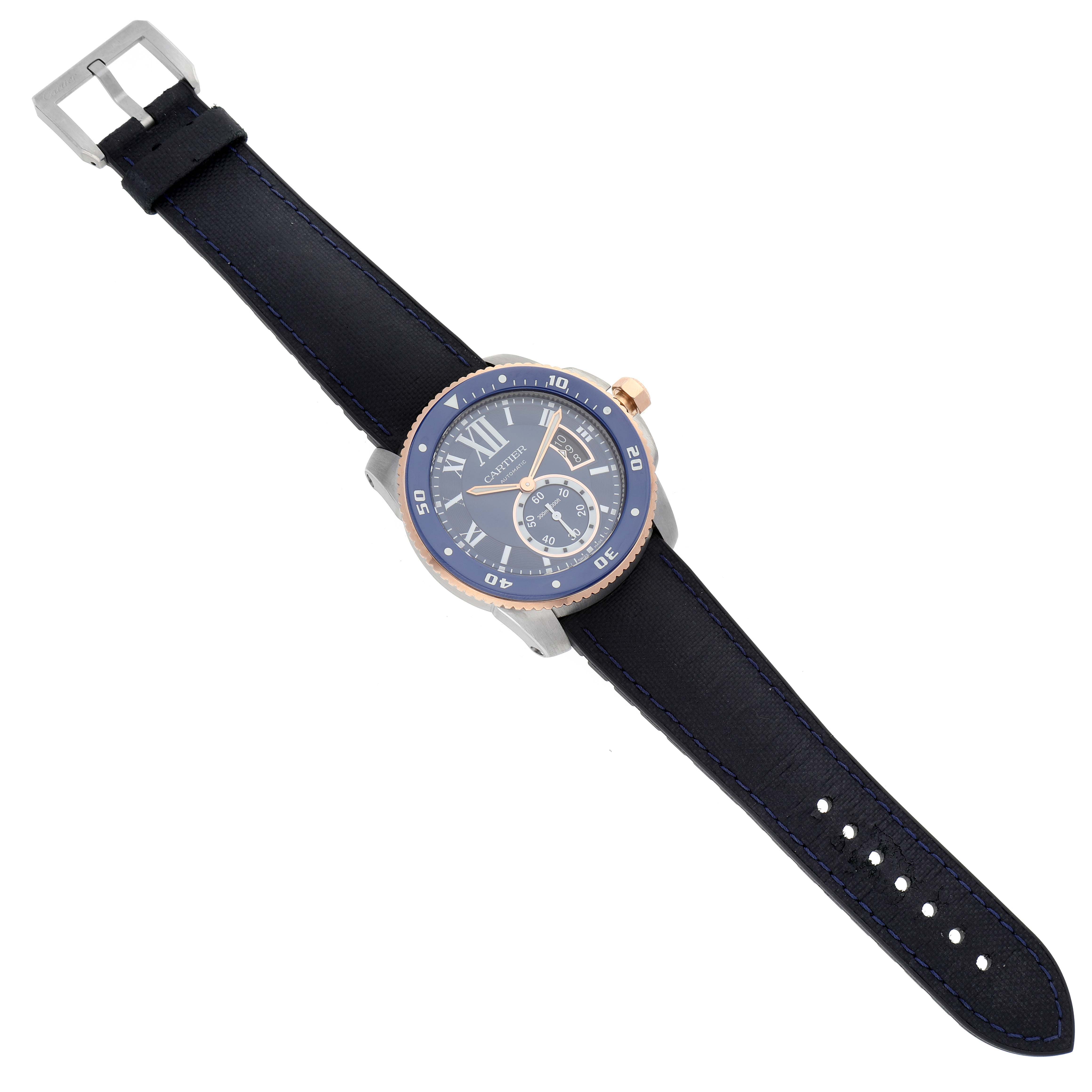 The Calibre de Cartier watch is shown from the top, displaying the face, bezel, crown, and black leather strap.