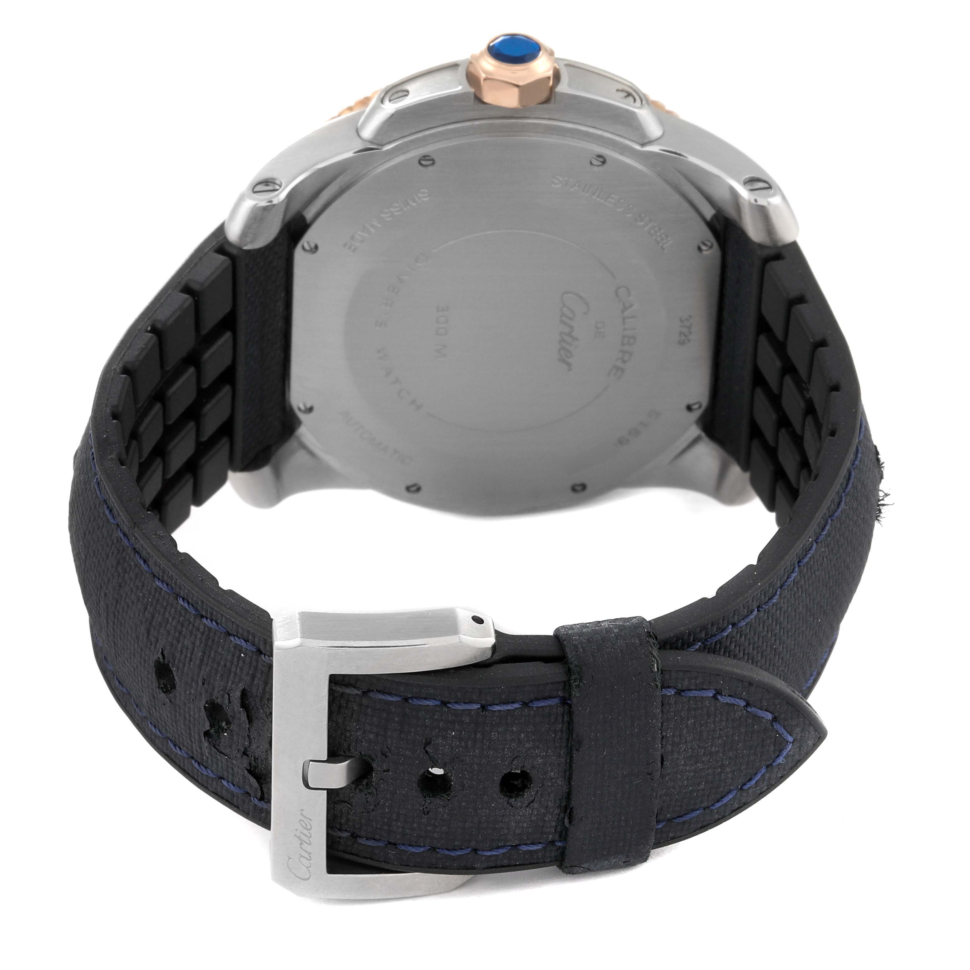 The image shows the rear view of a Calibre de Cartier watch by Cartier, highlighting the case back and the black strap with buckle.