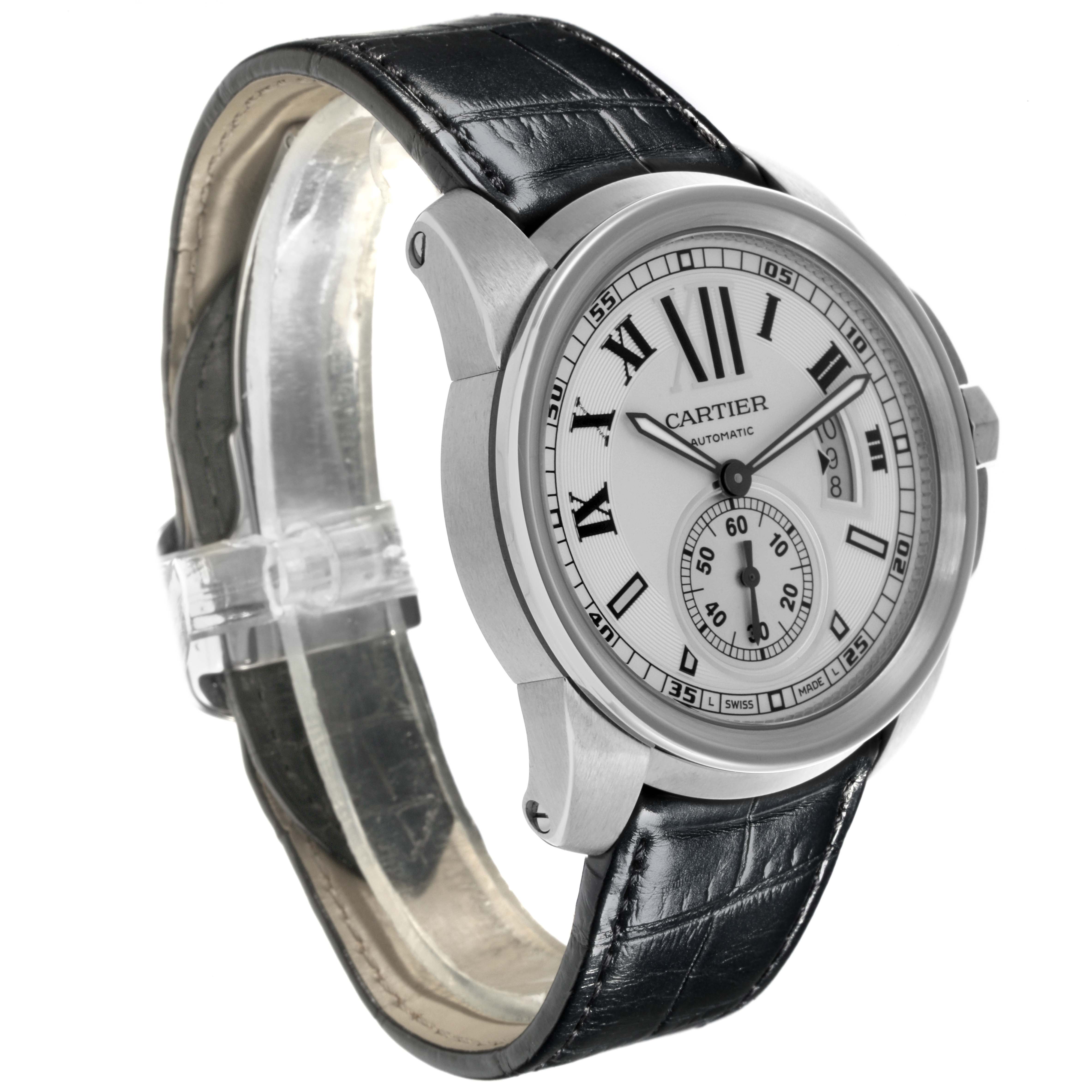 The Calibre de Cartier watch is shown at a slight angle, displaying the watch face, Roman numerals, and leather strap.