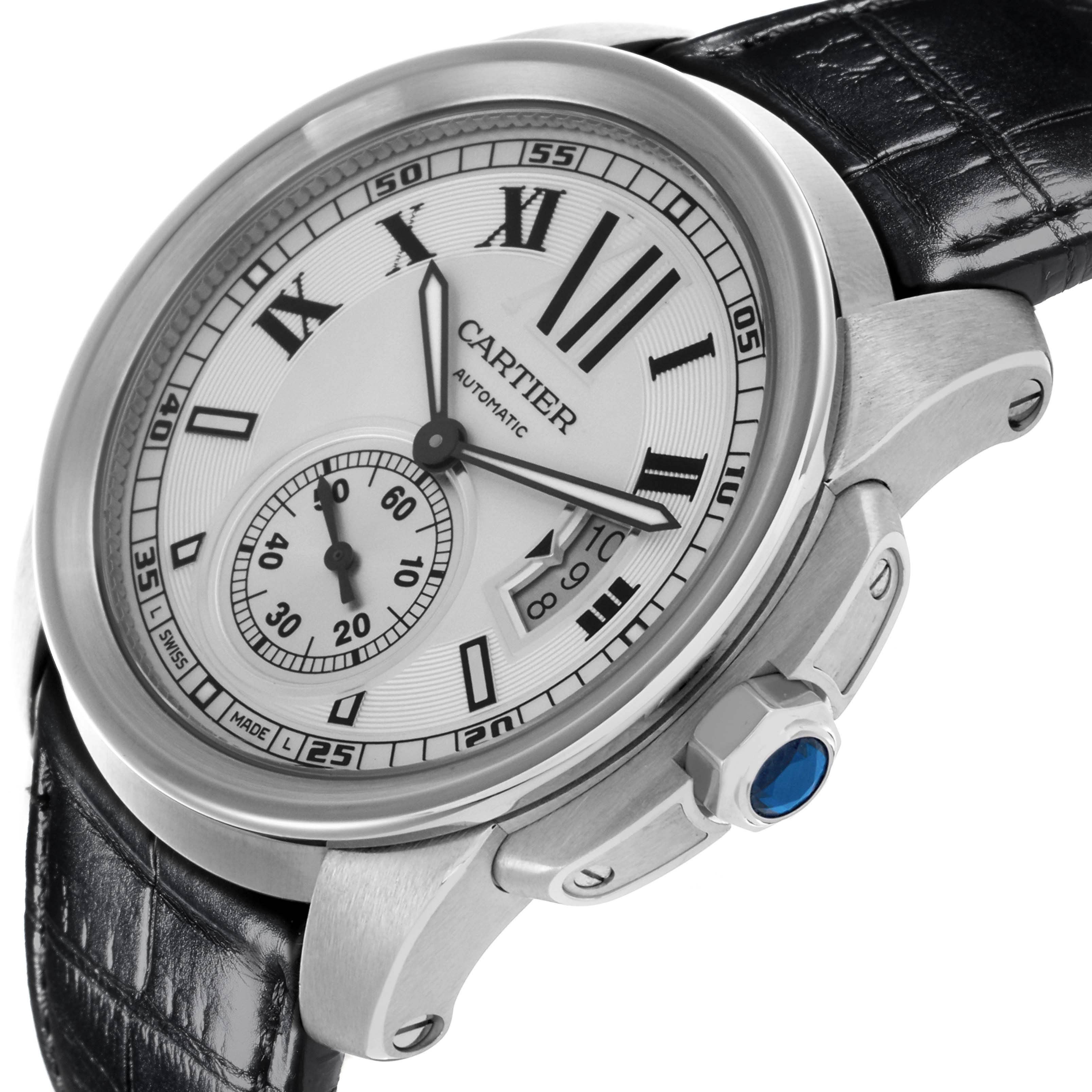 The Calibre de Cartier watch is shown at a slight angle, highlighting the dial, bezel, crown, and part of the strap.