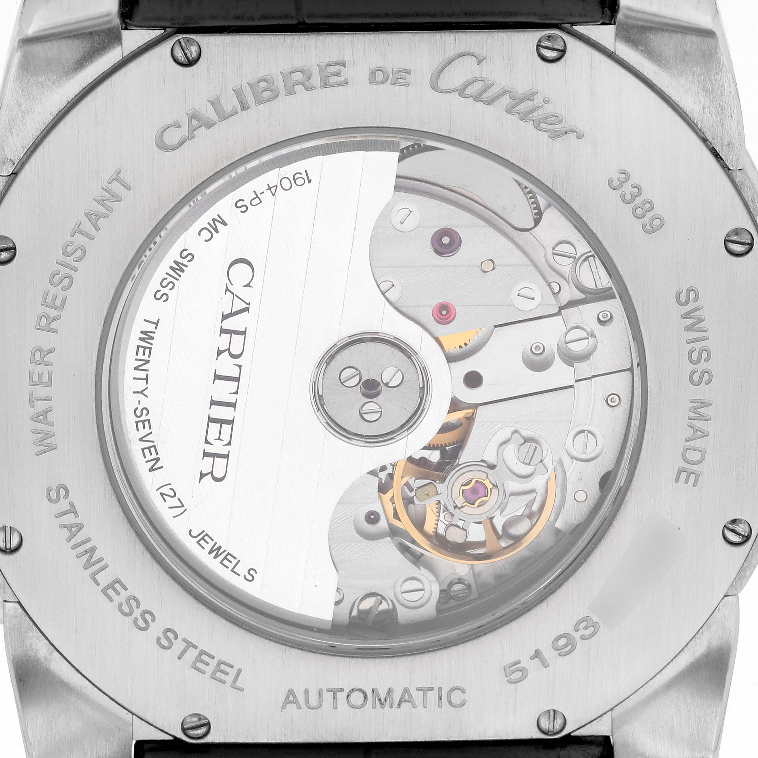 The image shows the back view of the Calibre de Cartier watch, featuring its automatic movement and engravings.