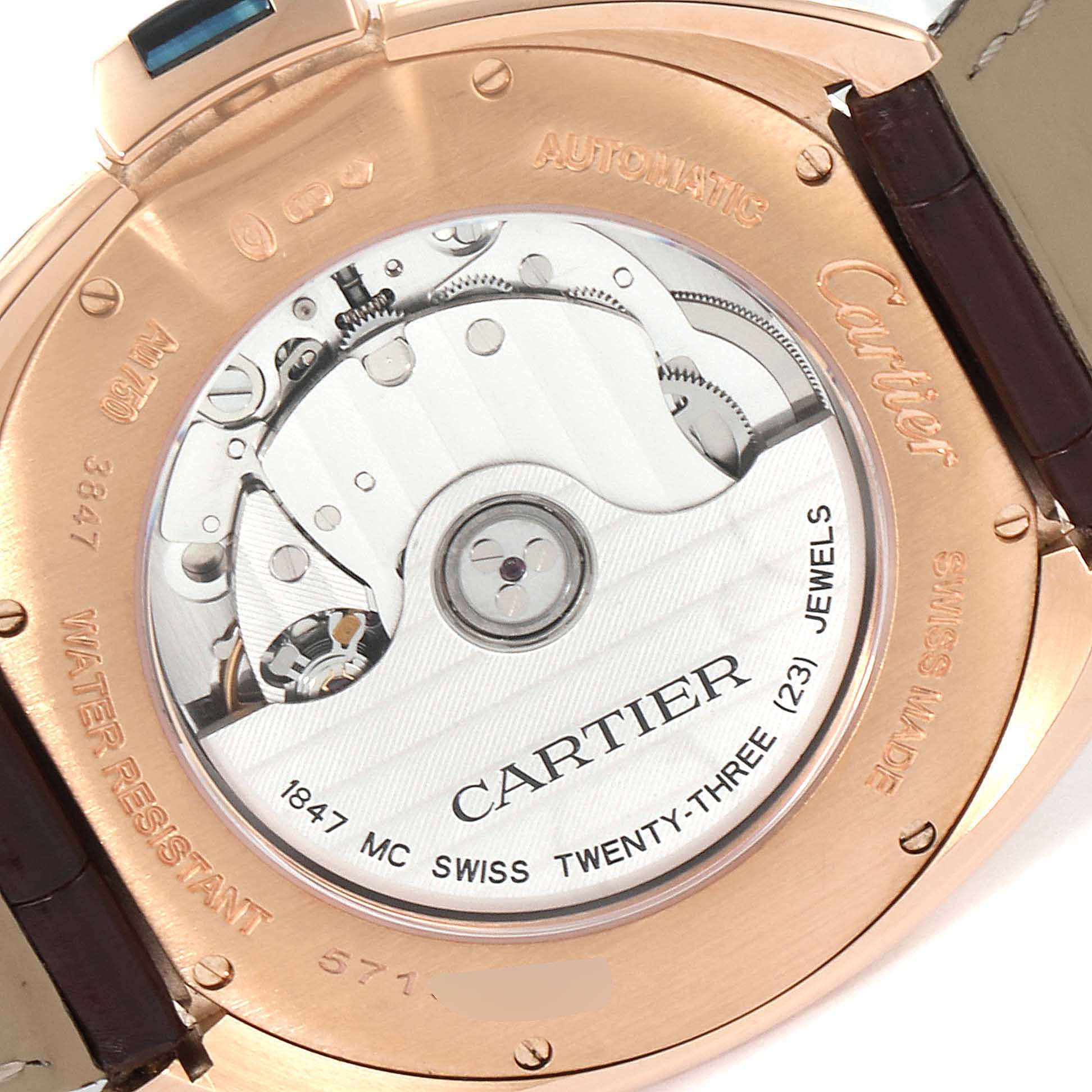 The image shows the back of a Cartier Clé model watch, highlighting its automatic movement and internal mechanism.