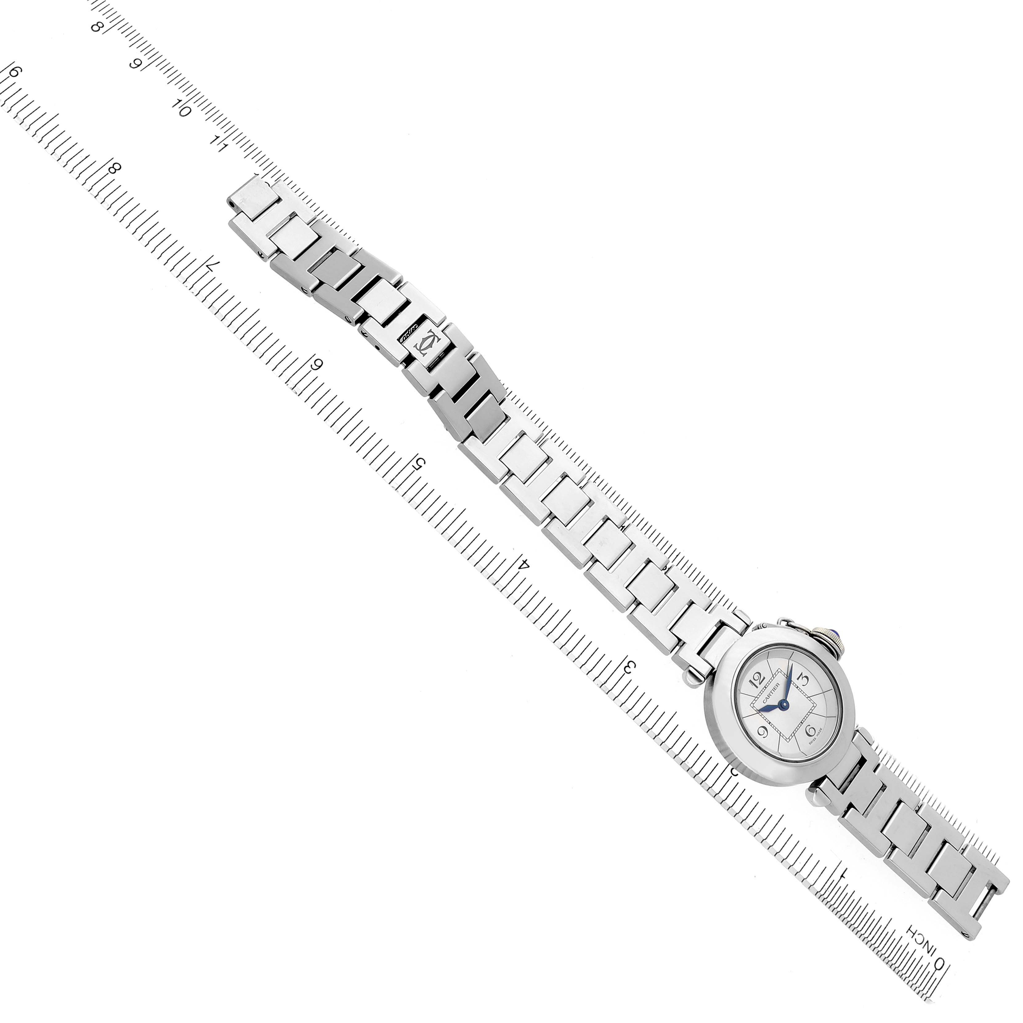 The Cartier Pasha W3140007 Women
s Stainless Steel Silver Dial W3140007 Women
s Stainless Steel Silver Dial watch is displayed flat with a full view of the face and bracelet on a ruler for size reference.