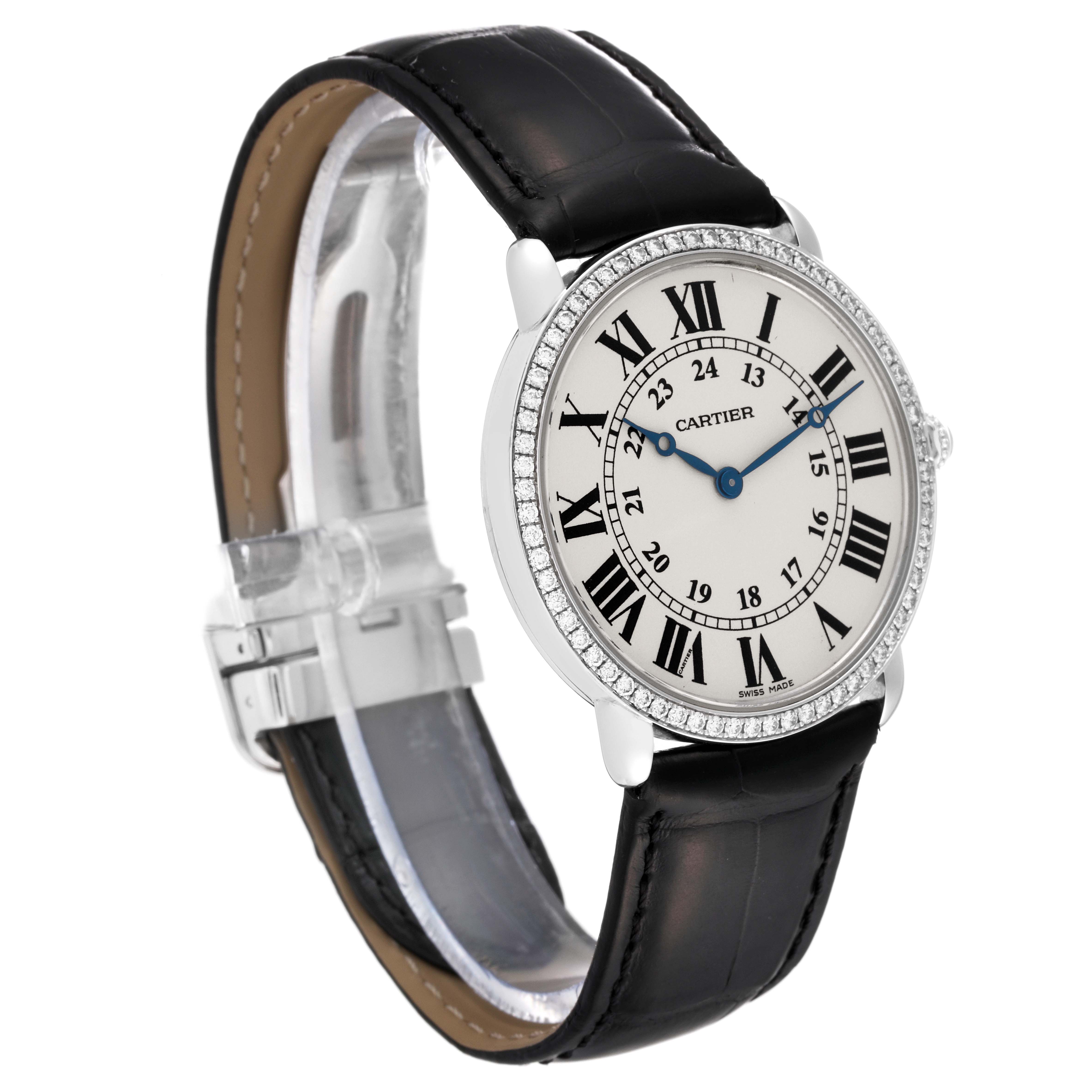 The Cartier Ronde WR000551 Men's White Gold Silver Dial WR000551 Men's White Gold Silver Dial watch is shown at an angle displaying the face, leather strap, and clasp.