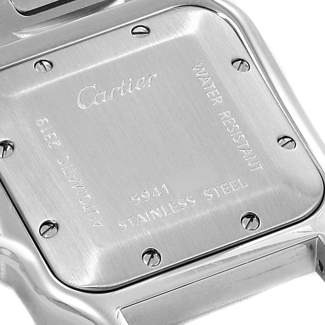 This image shows the stainless steel case back of a Cartier Santos W20055D6 Men's Stainless Steel Silver Dial W20055D6 Men's Stainless Steel Silver Dial watch, viewed from the top.
