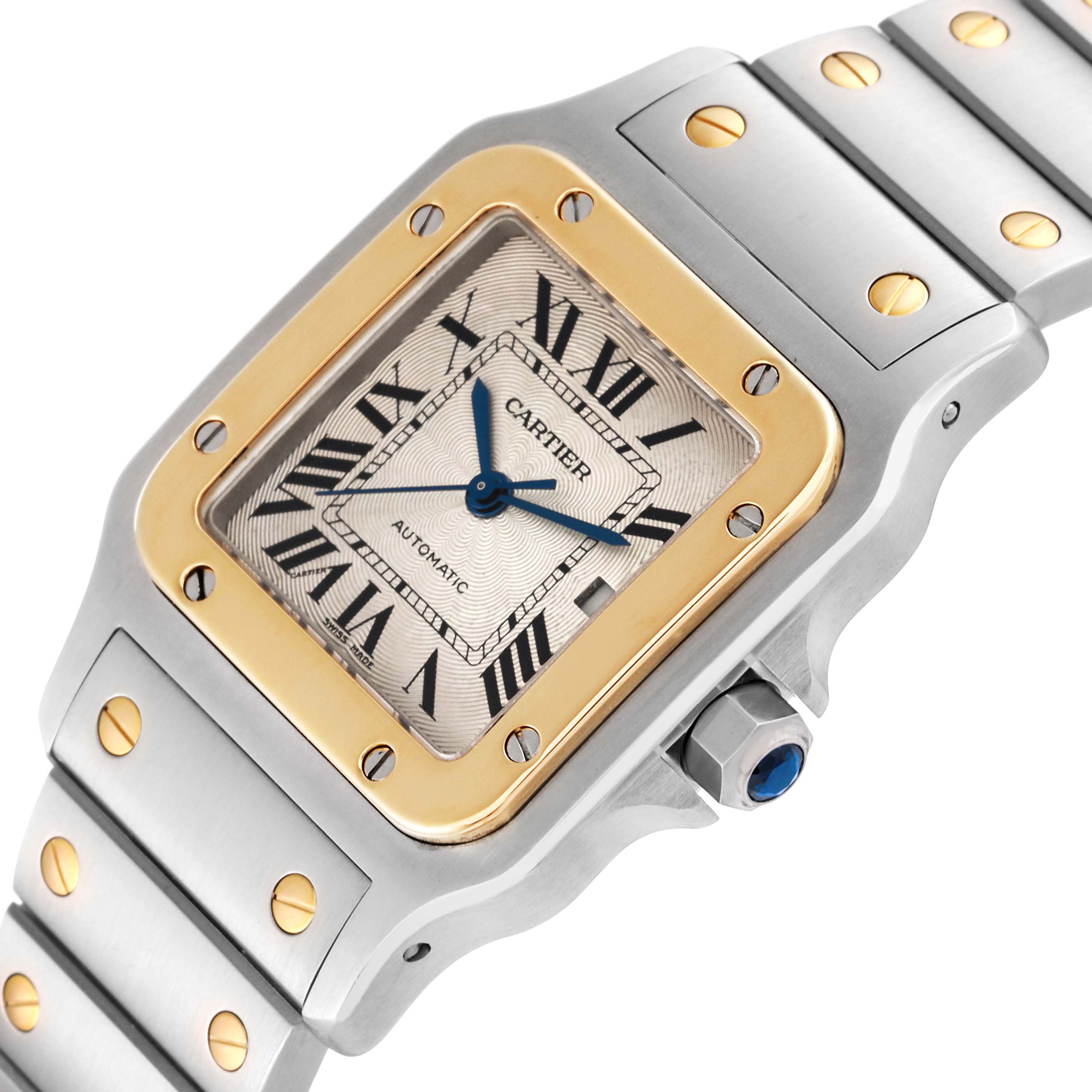 This image shows a close-up of the Cartier Santos W20058C4 Men
s Steel and Gold (two tone) Silver Dial W20058C4 Men
s Steel and Gold (two tone) Silver Dial model watch, focusing on the face, bezel, and part of the band.