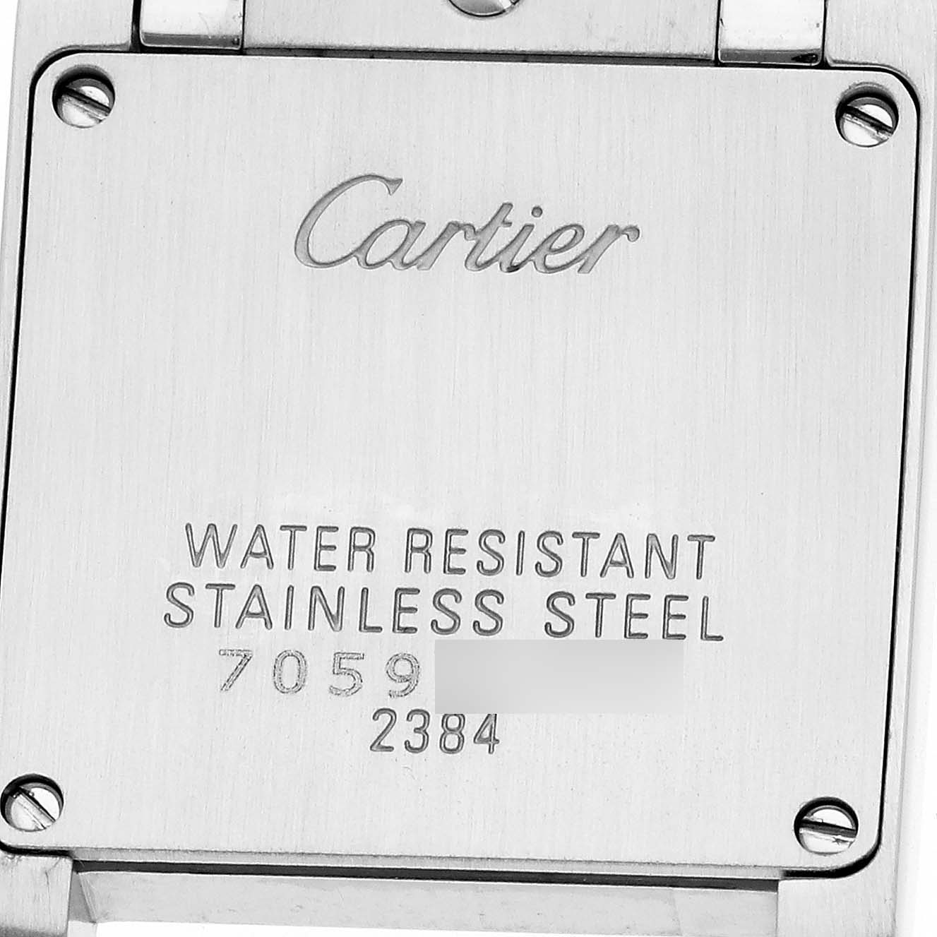 The image shows the back of the Cartier Tank Française watch with engravings of the brand and model details.