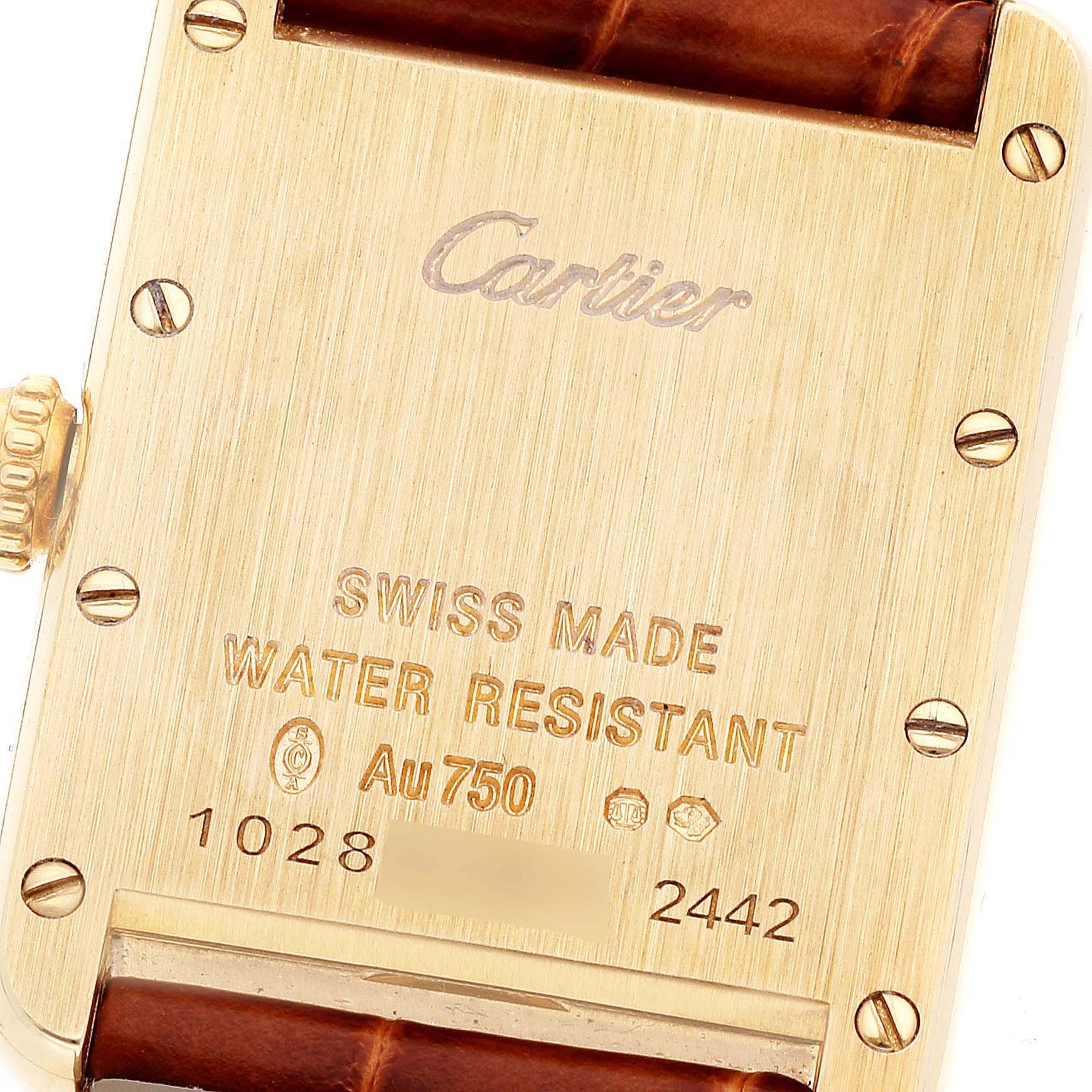 This image shows the back case of a Cartier Tank Louis W1529856 Women's Yellow Gold Silver Dial W1529856 Women's Yellow Gold Silver Dial watch, highlighting the engravings and the leather strap connection.