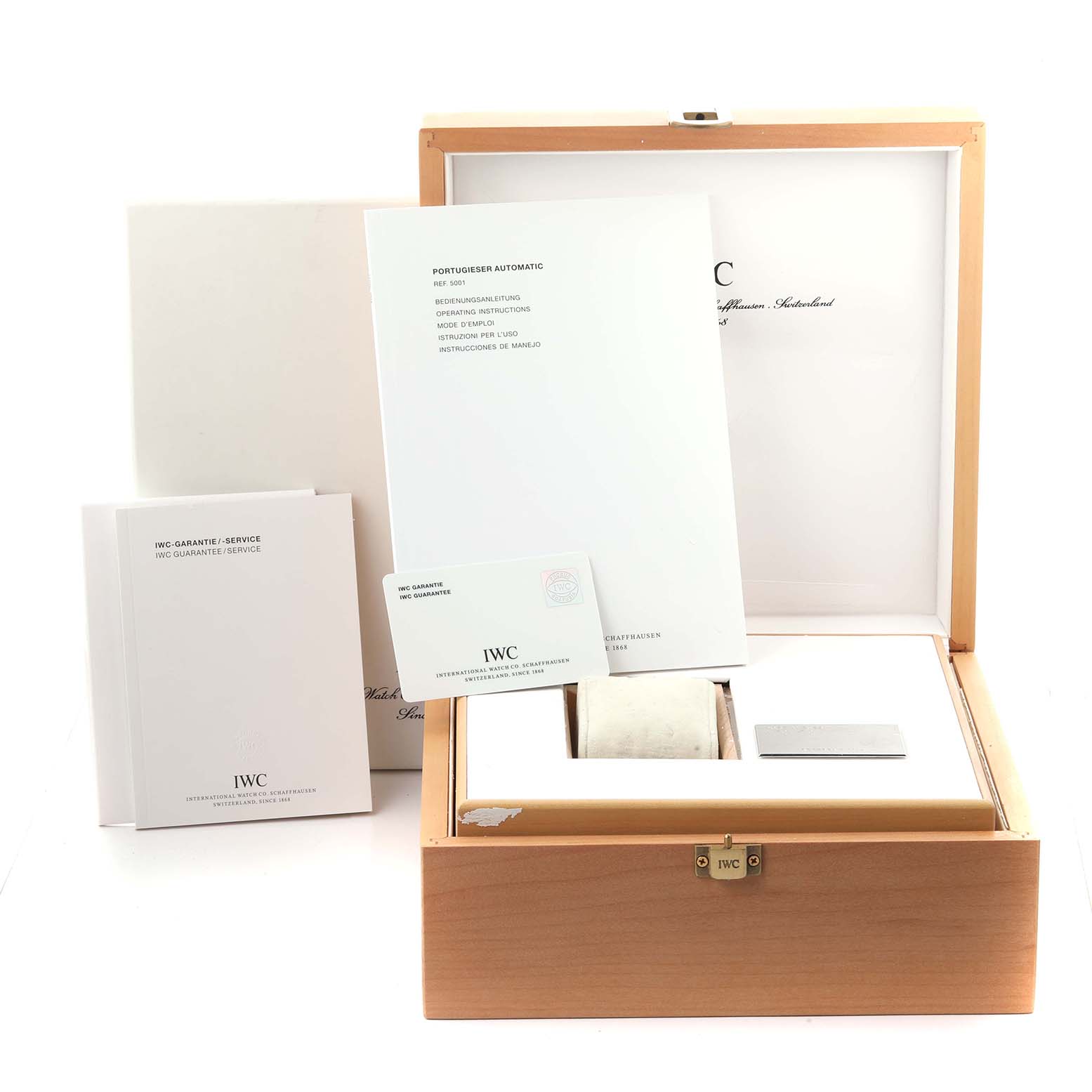 The image shows the IWC Portuguese IW500106 Men's White Gold Grey Dial IW500106 Men's White Gold Grey Dial model's packaging, manuals, and warranty card from a front angle.