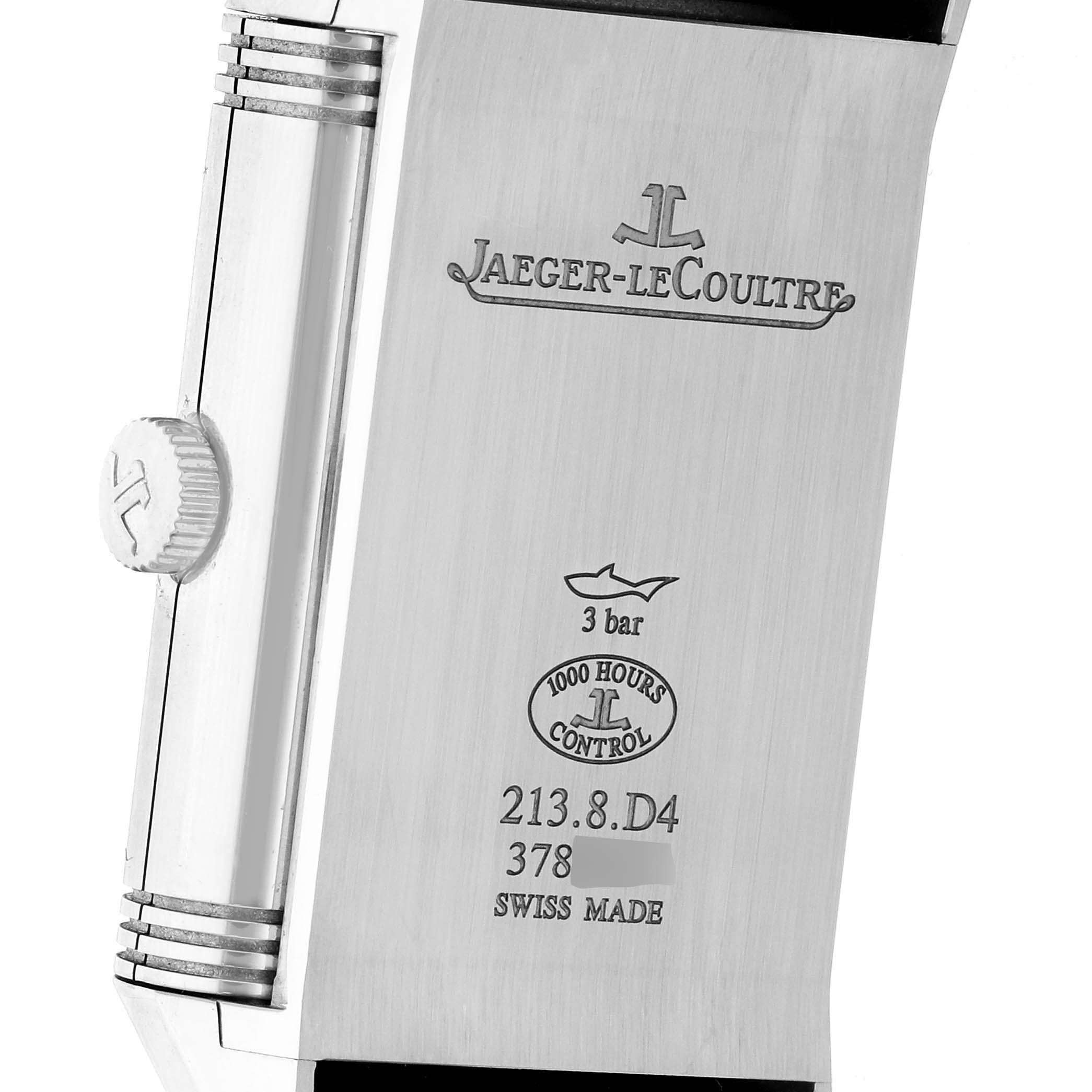 The image shows the back of a Jaeger-LeCoultre Reverso watch, featuring engraving and the side crown.