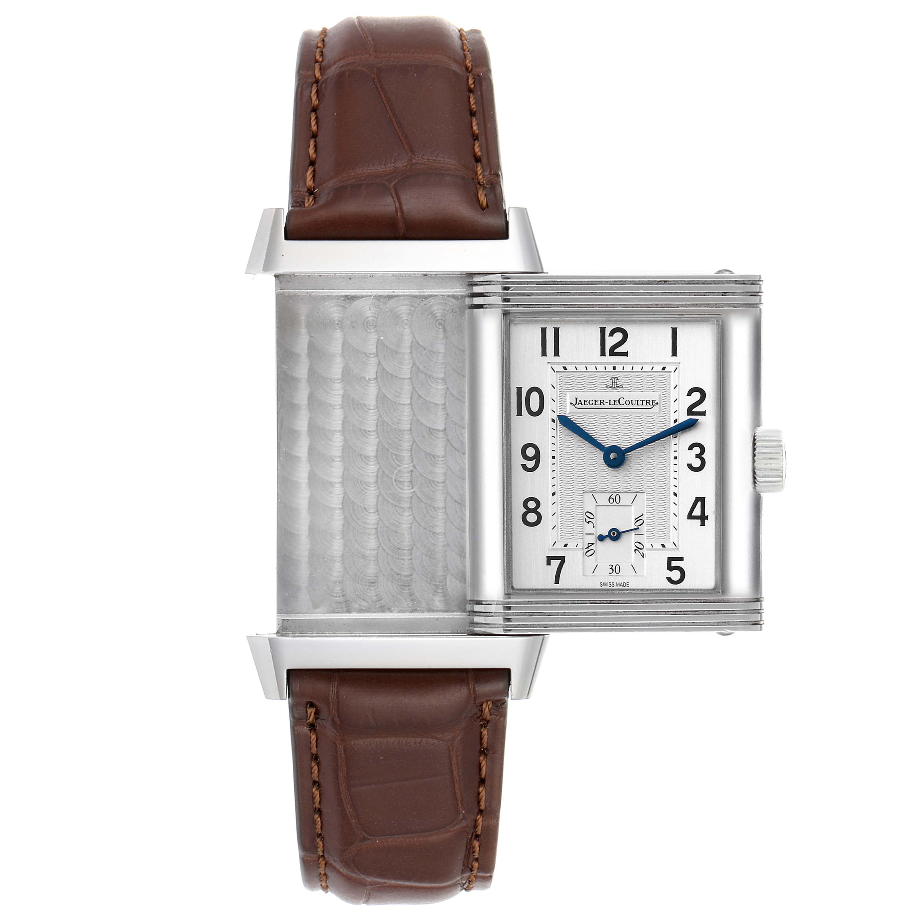 The image shows the Jaeger LeCoultre Reverso Q3858520 Men
s Stainless Steel Silver Dial Q3858520 Men
s Stainless Steel Silver Dial watch with its case flipped open, revealing the backside and the engraved dial.