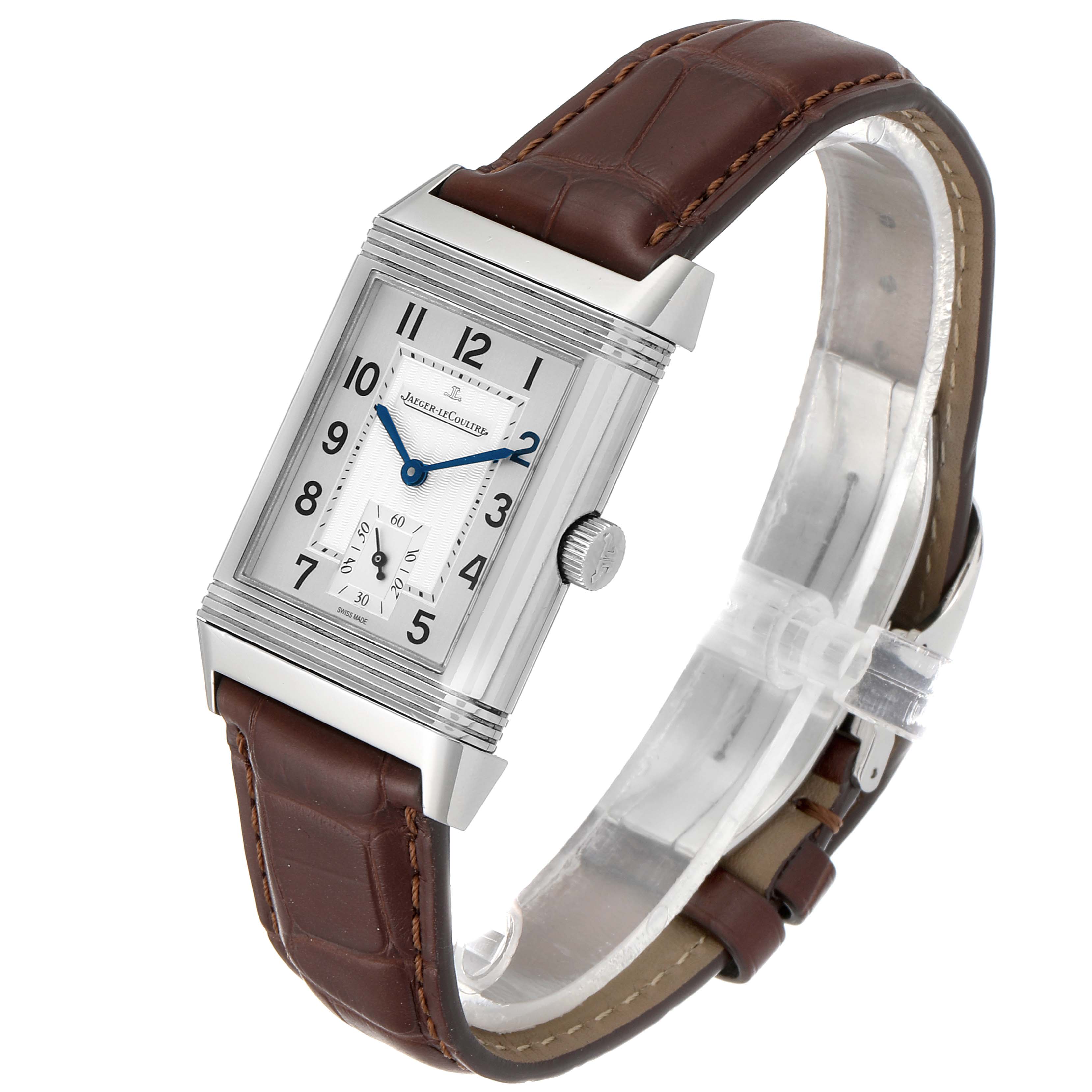 The image shows a Jaeger LeCoultre Reverso Q3858520 Men
s Stainless Steel Silver Dial Q3858520 Men
s Stainless Steel Silver Dial watch, angled to display the rectangular face, crown, and brown leather strap.