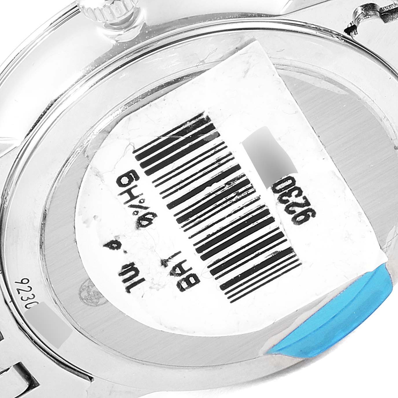 The image shows the back of an Omega 424.10.27.60.57.001 Women's Stainless Steel Mother of Pearl Dial 424.10.27.60.57.001 Women's Stainless Steel Mother of Pearl Dial DeVille Prestige MOP Diamond Ladies Watch 424.10.27.60.57.001, displaying a barcode sticker.