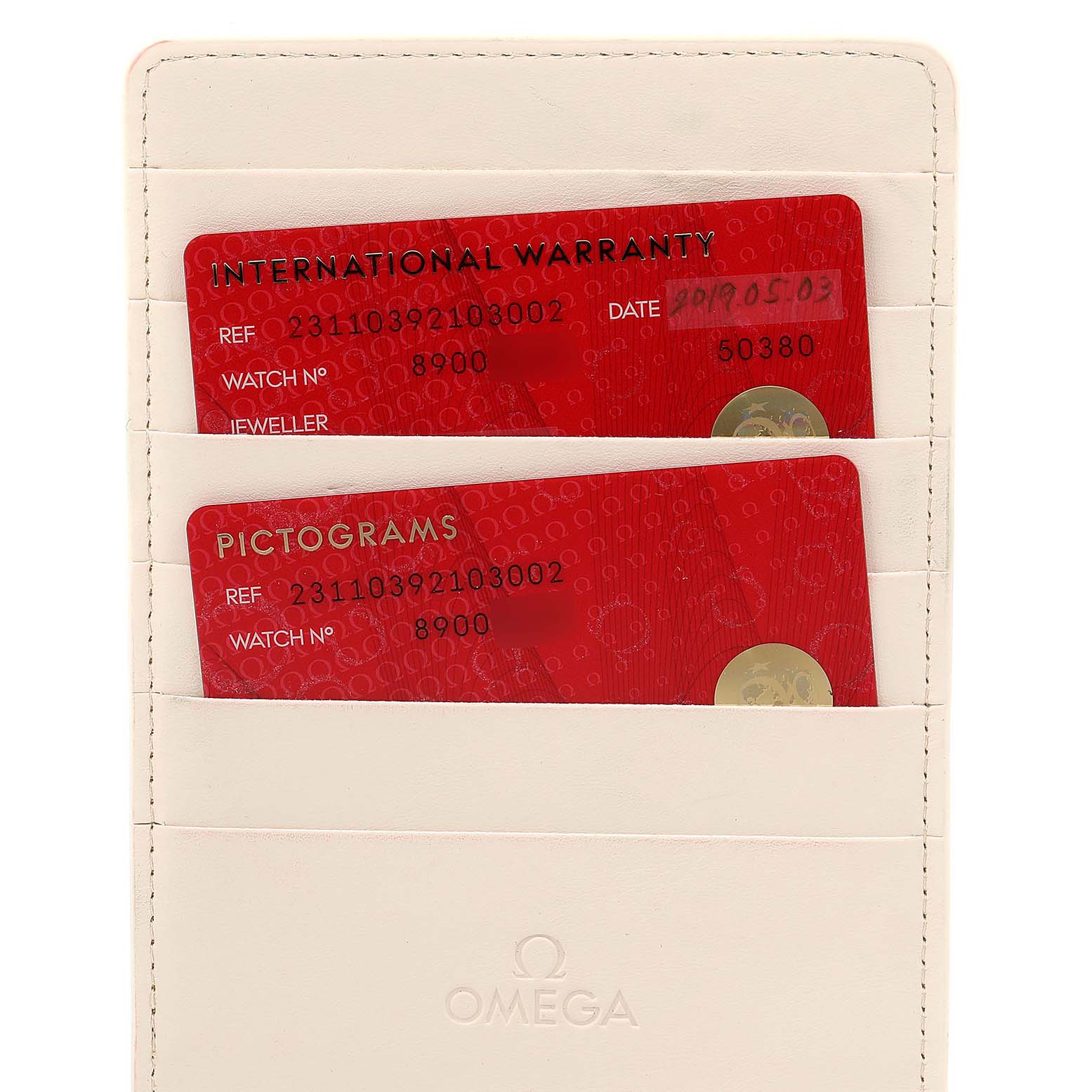 The image shows warranty and pictogram cards in a white Omega holder for the Omega Aqua Terra 231.10.39.21.03.002 Men
s Stainless Steel Blue Dial 231.10.39.21.03.002 Men
s Stainless Steel Blue Dial model watch.