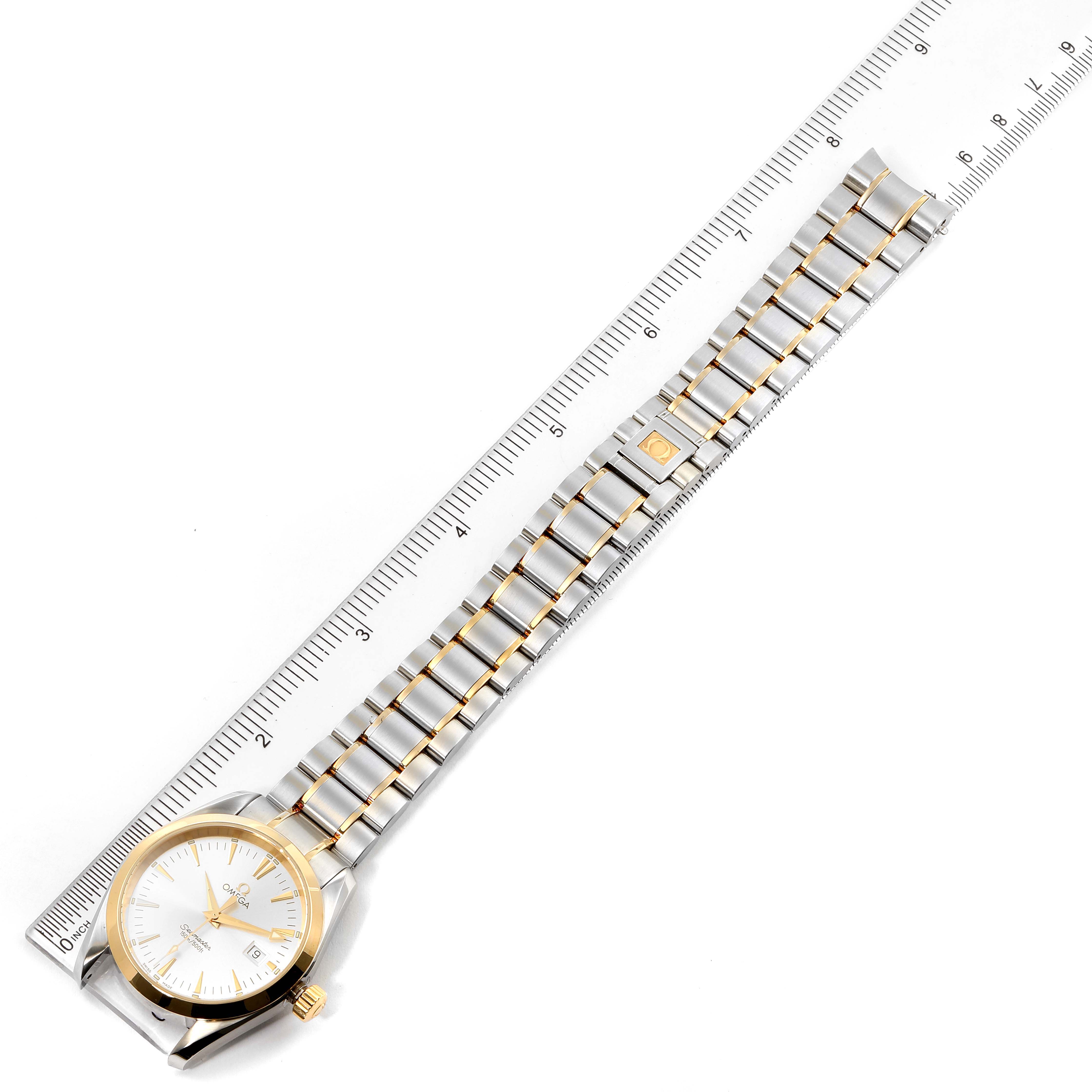 This image shows an Omega Aqua Terra 2318.30.00 Men's Steel and Gold (two tone) Silver Dial 2318.30.00 Men's Steel and Gold (two tone) Silver Dial watch laid flat with a ruler, displaying its face, bezel, and entire bracelet.
