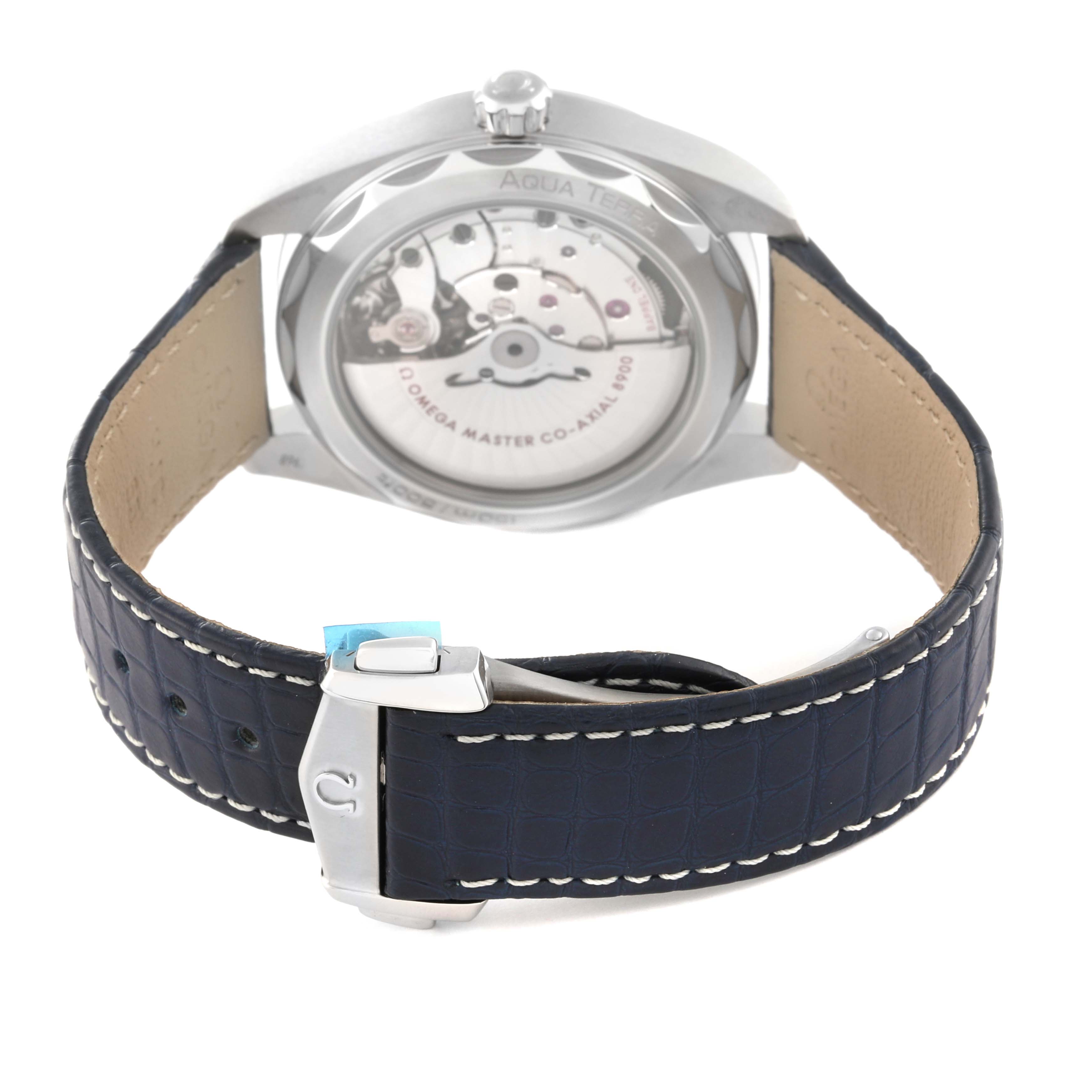 The image shows the back of an Omega Aqua Terra 220.13.41.21.03.002 Men's Stainless Steel Blue Dial 220.13.41.21.03.002 Men's Stainless Steel Blue Dial watch featuring its transparent case back and leather strap with a clasp.