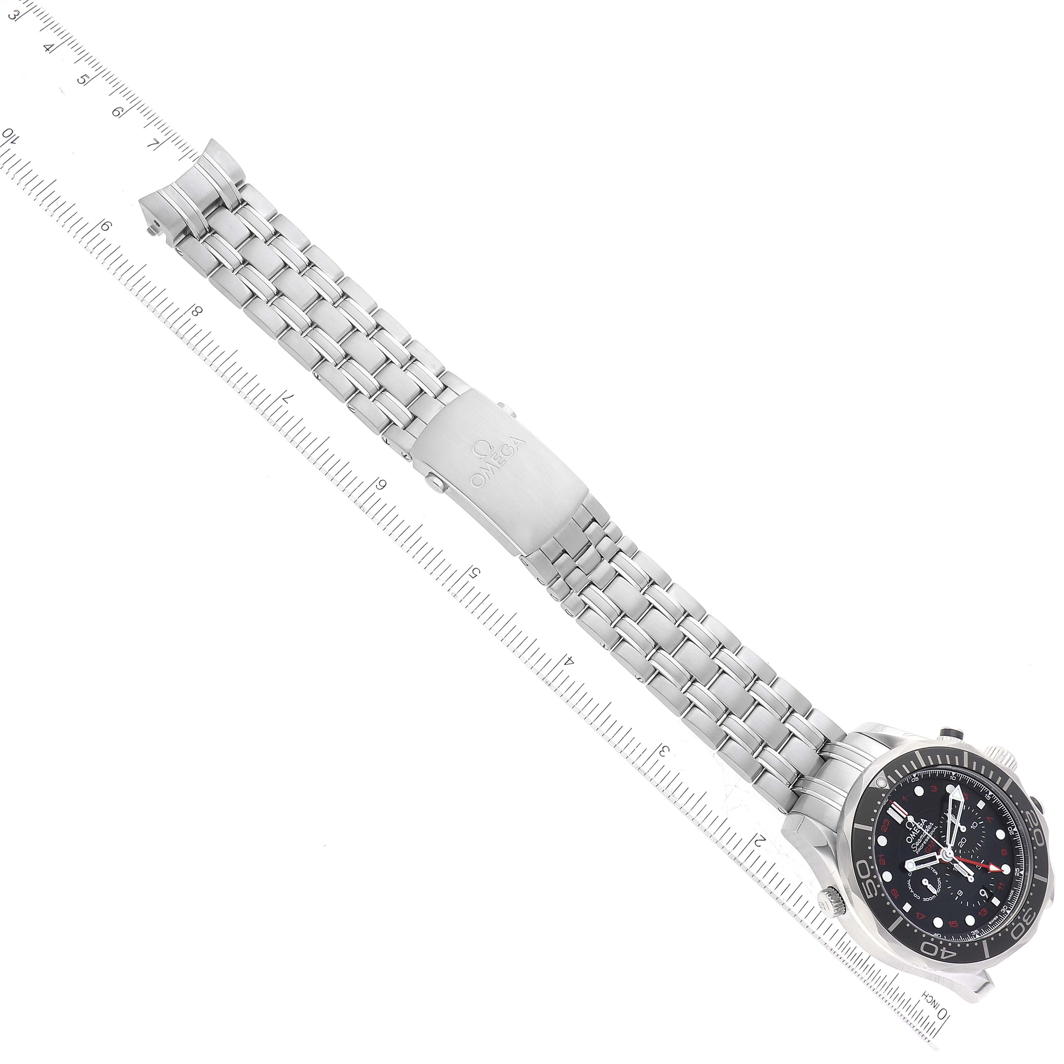This image shows the Omega Seamaster 212.30.44.52.01.001 Men
s Stainless Steel Black Dial 212.30.44.52.01.001 Men
s Stainless Steel Black Dial watch laid flat with its metal bracelet and clasp extended next to a ruler.