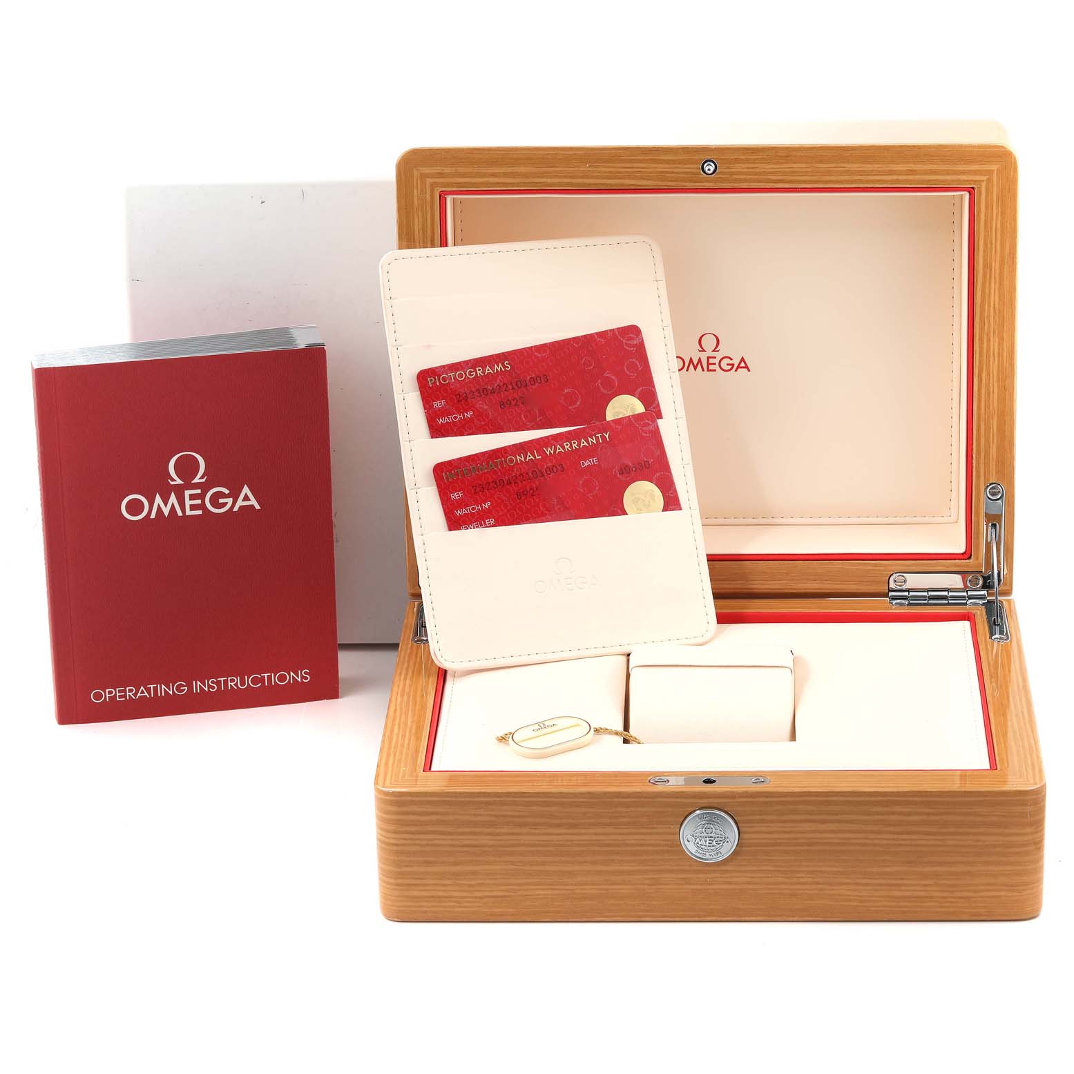 The image shows the accessories for an Omega Planet Ocean 232.30.42.21.01.003 Men
s Stainless Steel Black Dial 232.30.42.21.01.003 Men
s Stainless Steel Black Dial watch, including the box, warranty cards, and operating instructions.