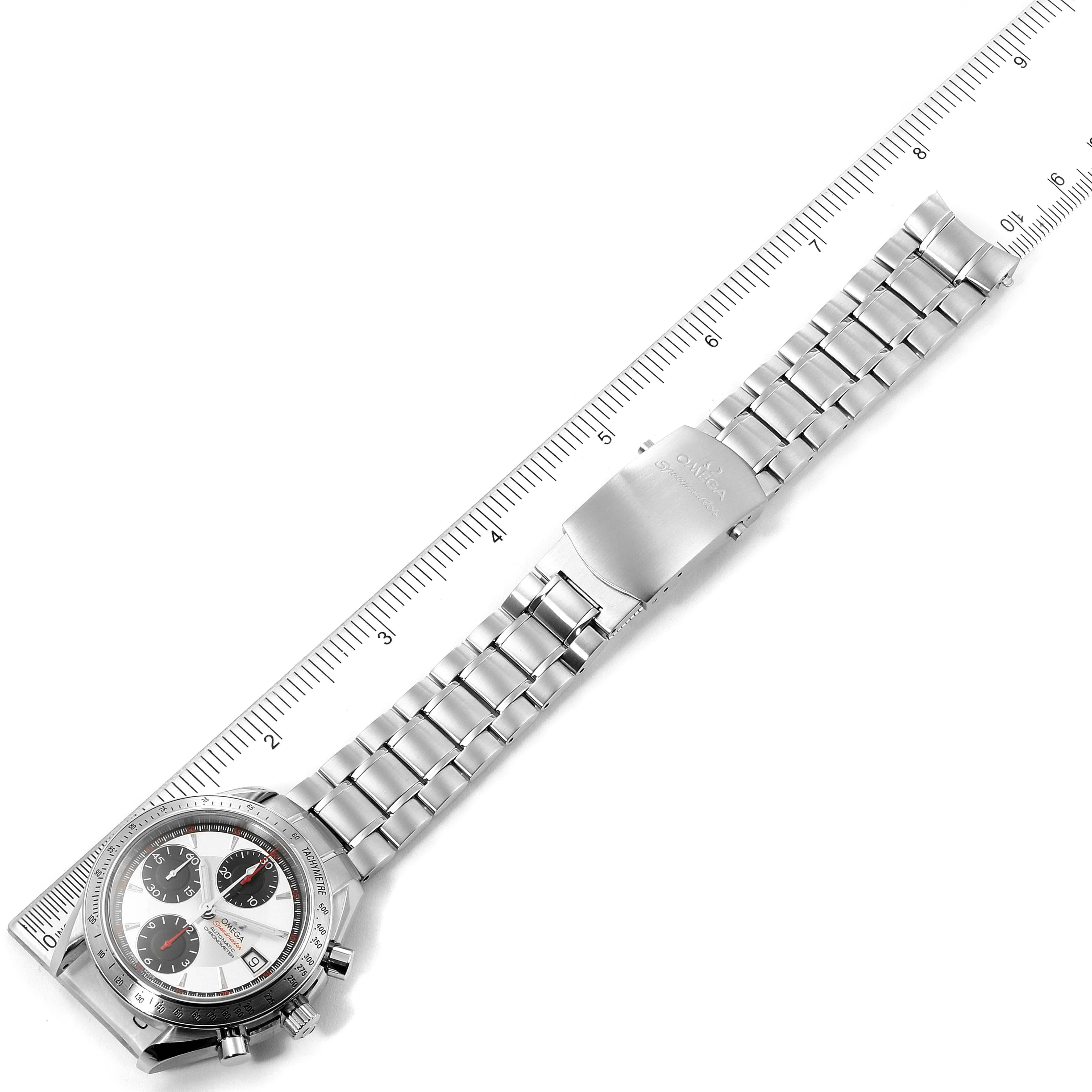 The Omega Speedmaster 3211.31.00 Men's Stainless Steel Silver Dial 3211.31.00 Men's Stainless Steel Silver Dial watch is shown from a top-down angle with its bracelet and clasp extended beside a ruler.