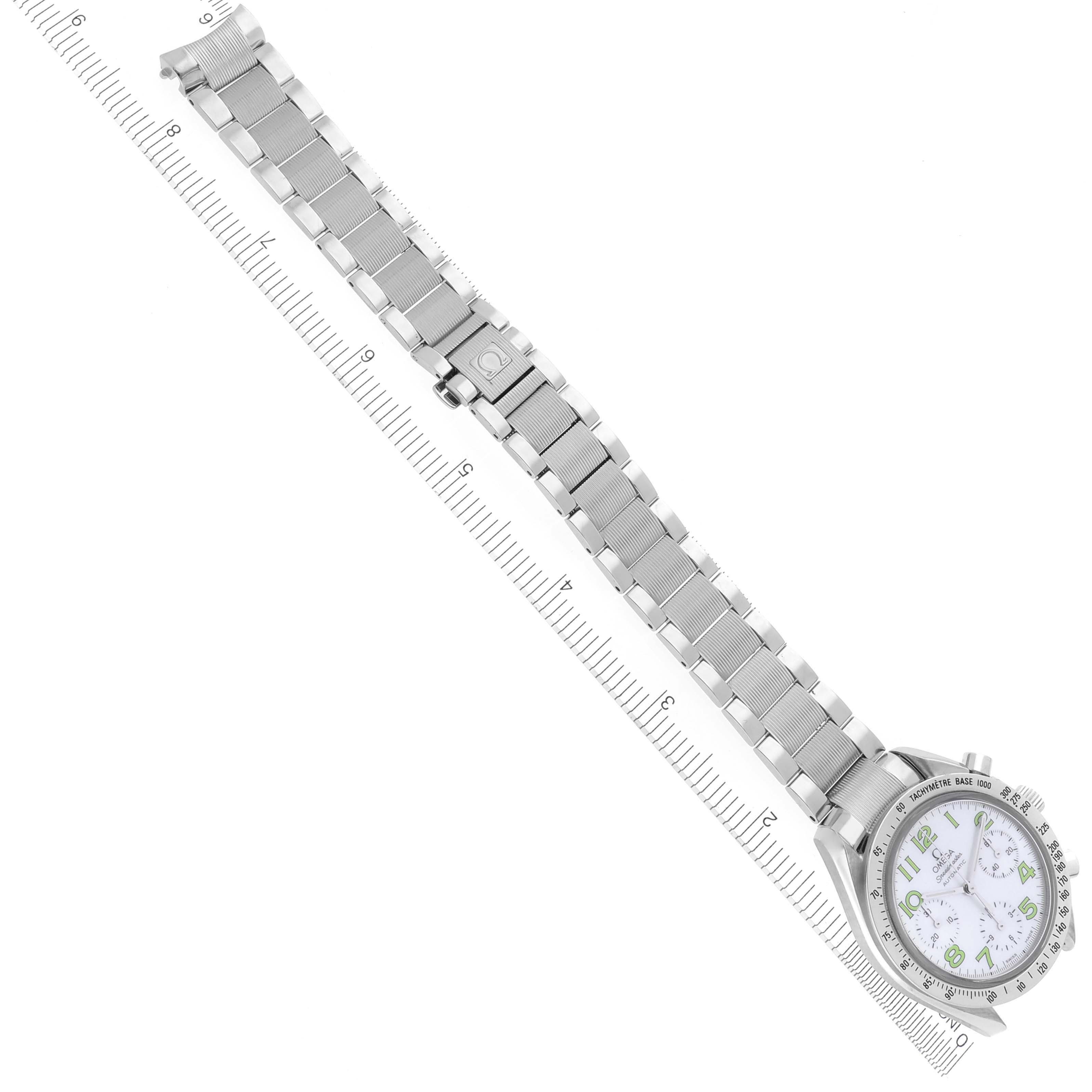 The Omega Speedmaster 3534.72.00 Men's Stainless Steel Mother of Pearl Dial 3534.72.00 Men's Stainless Steel Mother of Pearl Dial watch is shown from an overhead angle, displaying the full dial and bracelet laid next to a ruler.