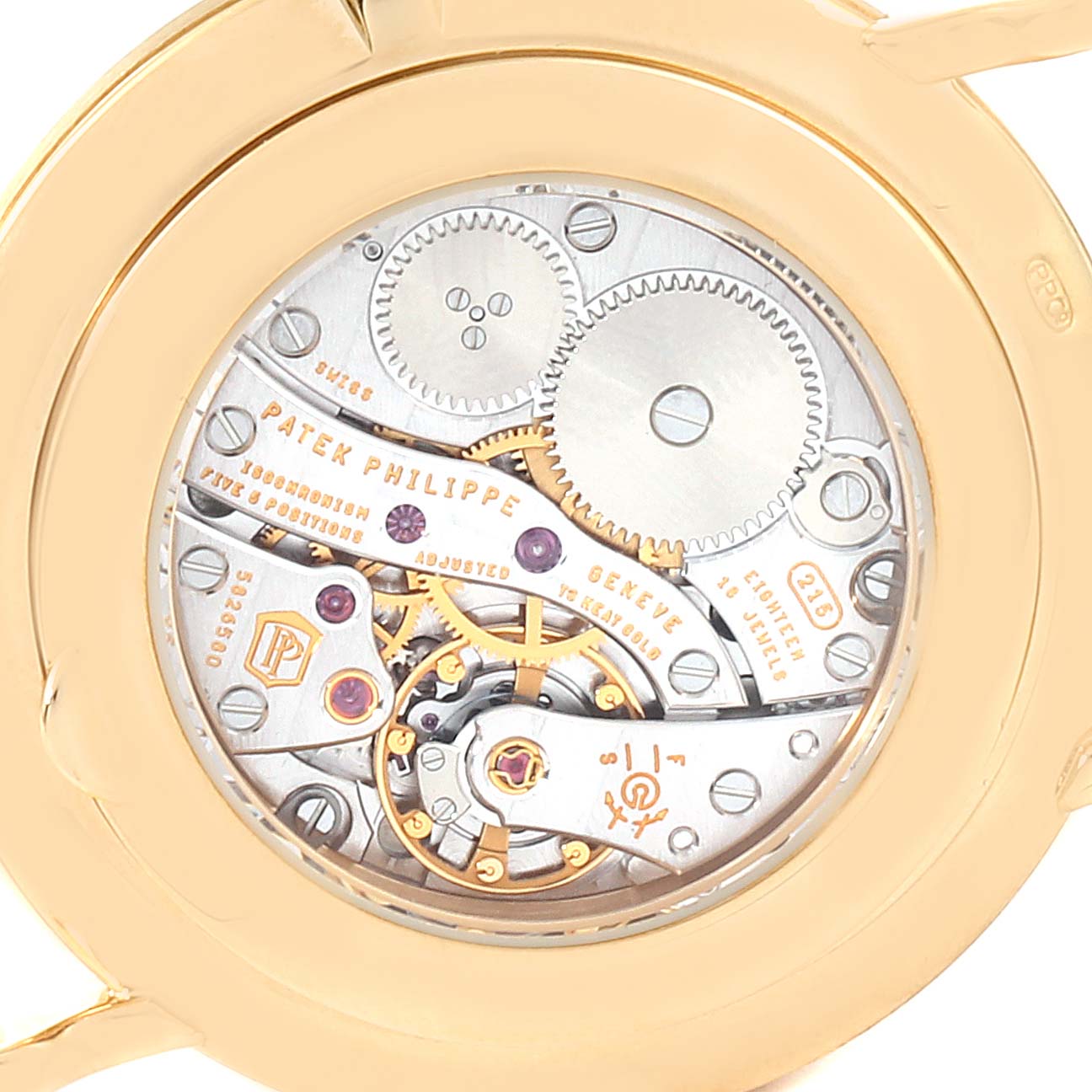 This is a close-up view of the movement mechanism of a Patek Philippe Calatrava 5119J Men's Yellow Gold White Dial 5119J Men's Yellow Gold White Dial watch showing gears and intricate details.