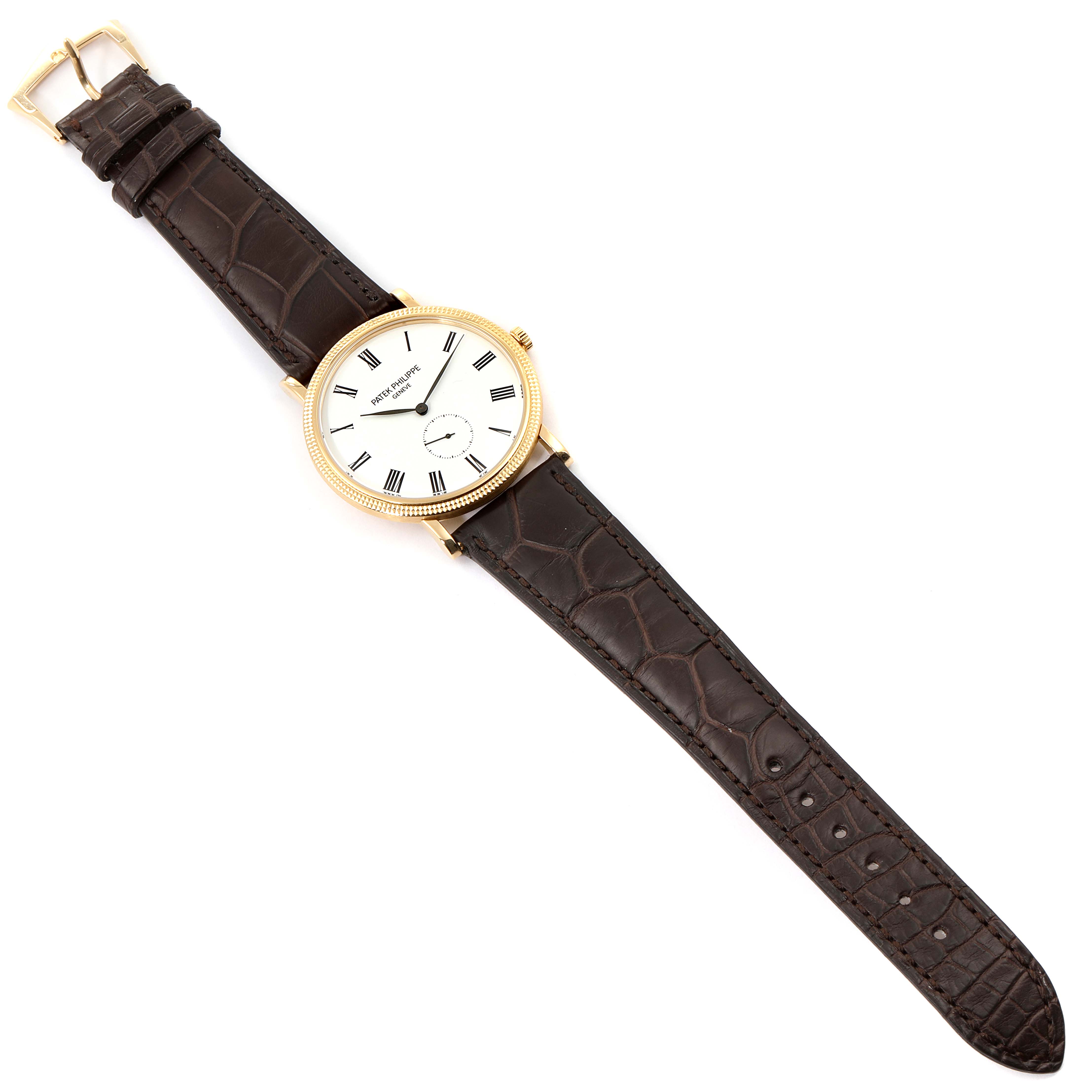 The image shows a full-view angle of a Patek Philippe Calatrava 5119J Men's Yellow Gold White Dial 5119J Men's Yellow Gold White Dial watch with a brown leather strap and a gold case.