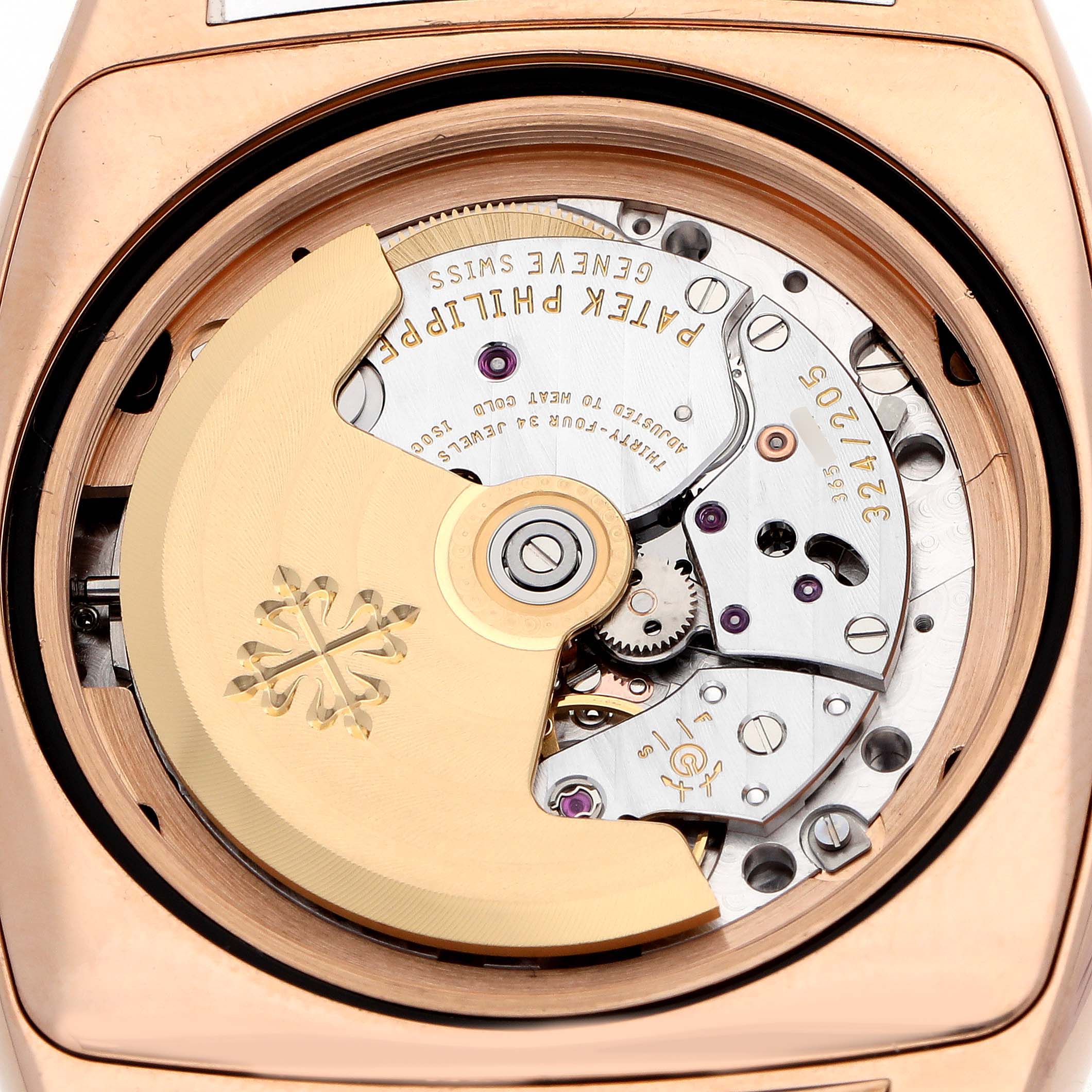 The image shows a close-up of the movement of a Patek Philippe Gondolo 5135 5135R Men's Rose Gold White Dial watch, highlighting the rotor and gears.