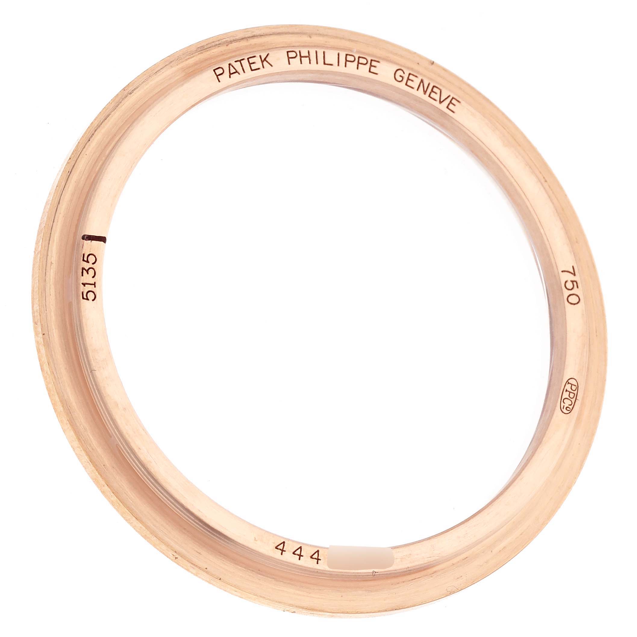 The image shows a gold bezel for the Patek Philippe Gondolo 5135 5135R Men's Rose Gold White Dial watch, viewed from an angle that highlights the engraved details.