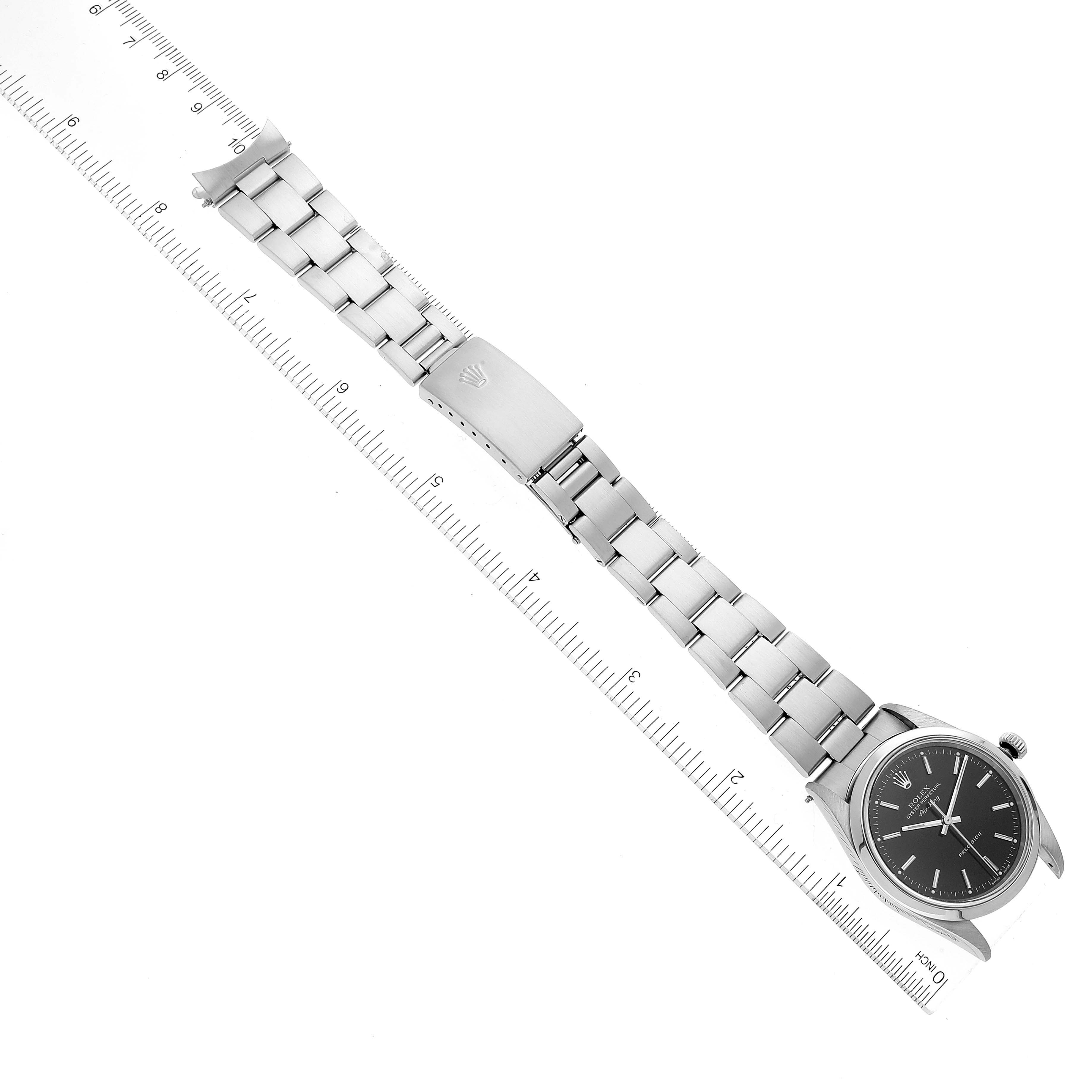 The image shows a full view of a Rolex Air-King 14000M Men's Stainless Steel Black Dial 14000M Men's Stainless Steel Black Dial watch lying flat, highlighting its dial, bracelet, and clasp against a ruler for scale.