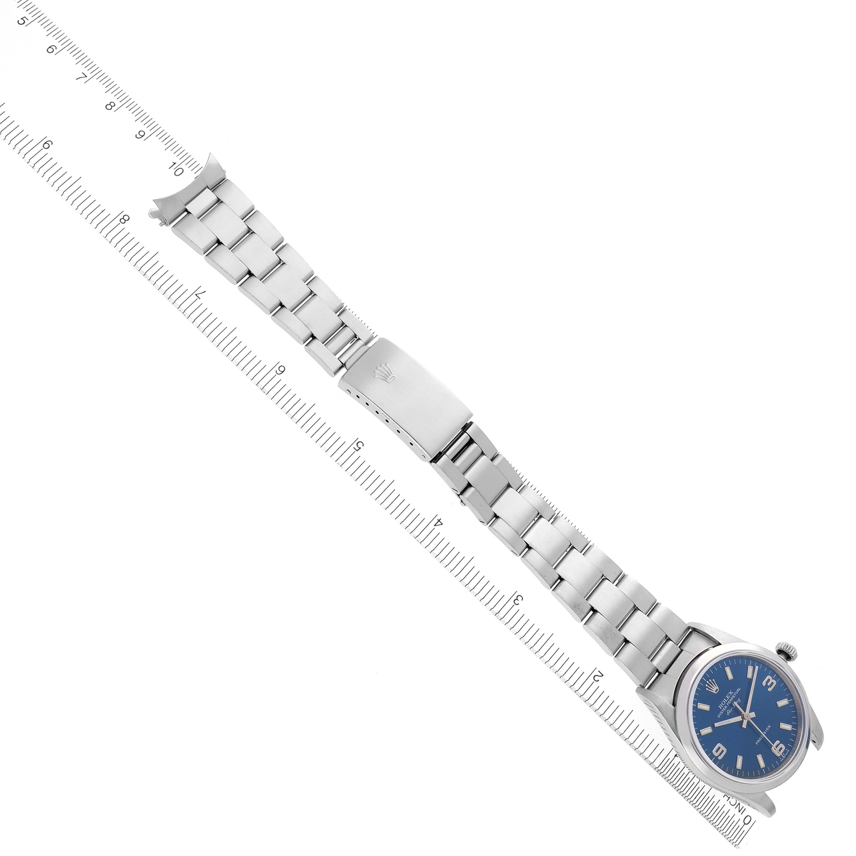 The Rolex Air-King 14000M Men's Stainless Steel Blue Dial 14000M Men's Stainless Steel Blue Dial watch is shown angled with the full bracelet and dial displayed alongside a ruler for measurement.