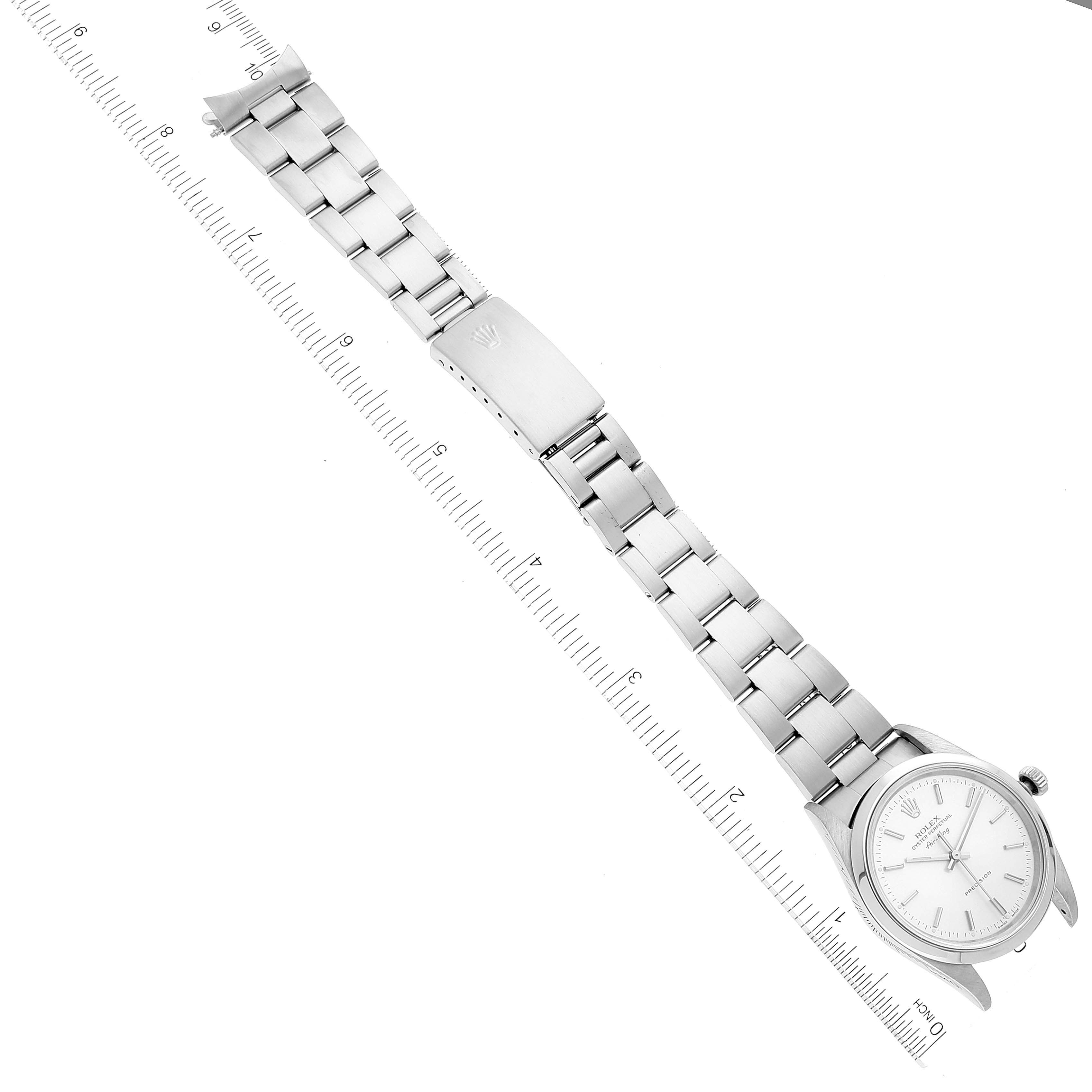 This image shows a side view of a Rolex Air-King 14000 Men's Stainless Steel Silver Dial 14000 Men's Stainless Steel Silver Dial watch with its full metal bracelet and clasp, alongside a measuring ruler.