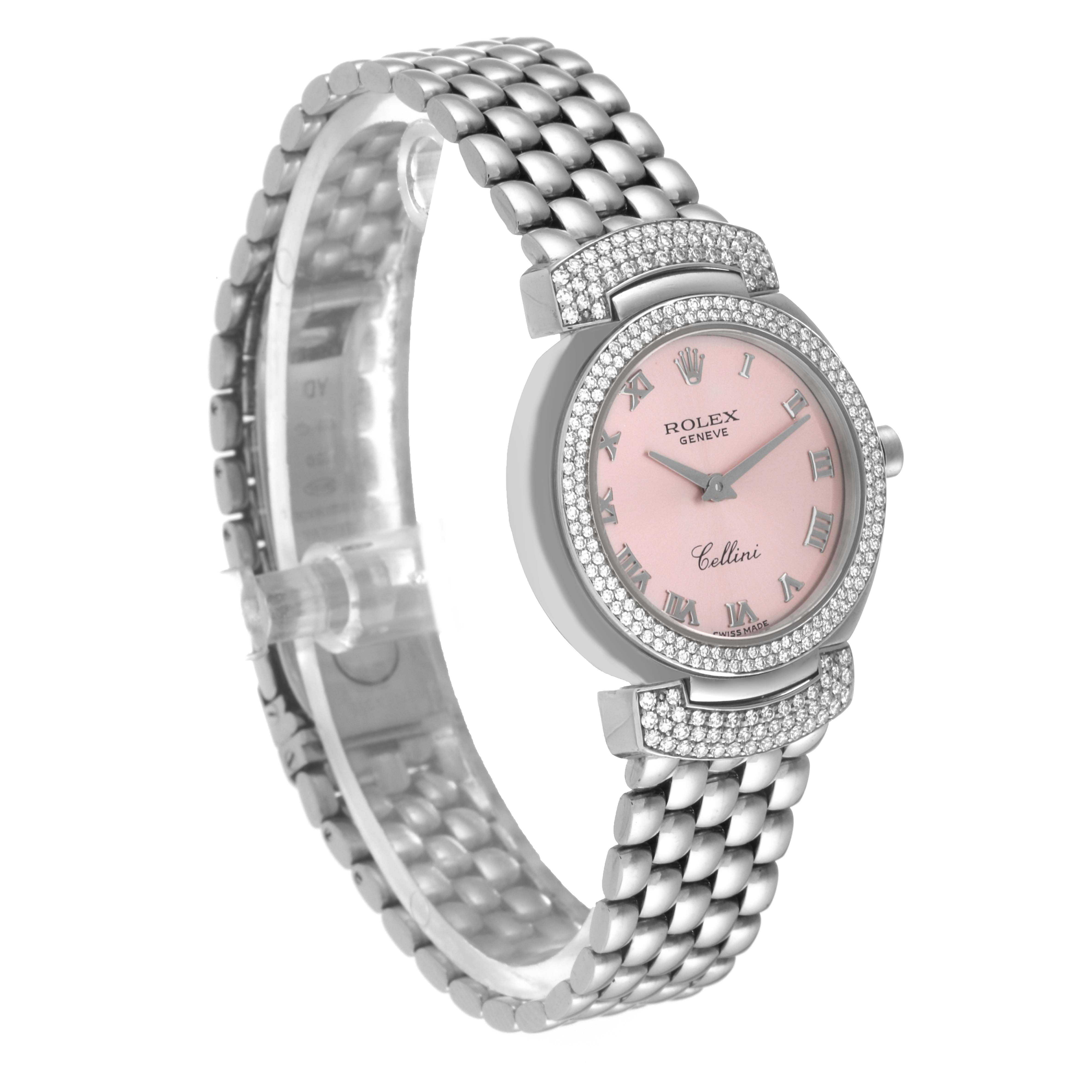 This image shows a Rolex Cellini 6673 Women
s White Gold Pink Dial 6673 Women
s White Gold Pink Dial watch at a slight angle, displaying its pink dial, Roman numerals, and metallic bracelet.