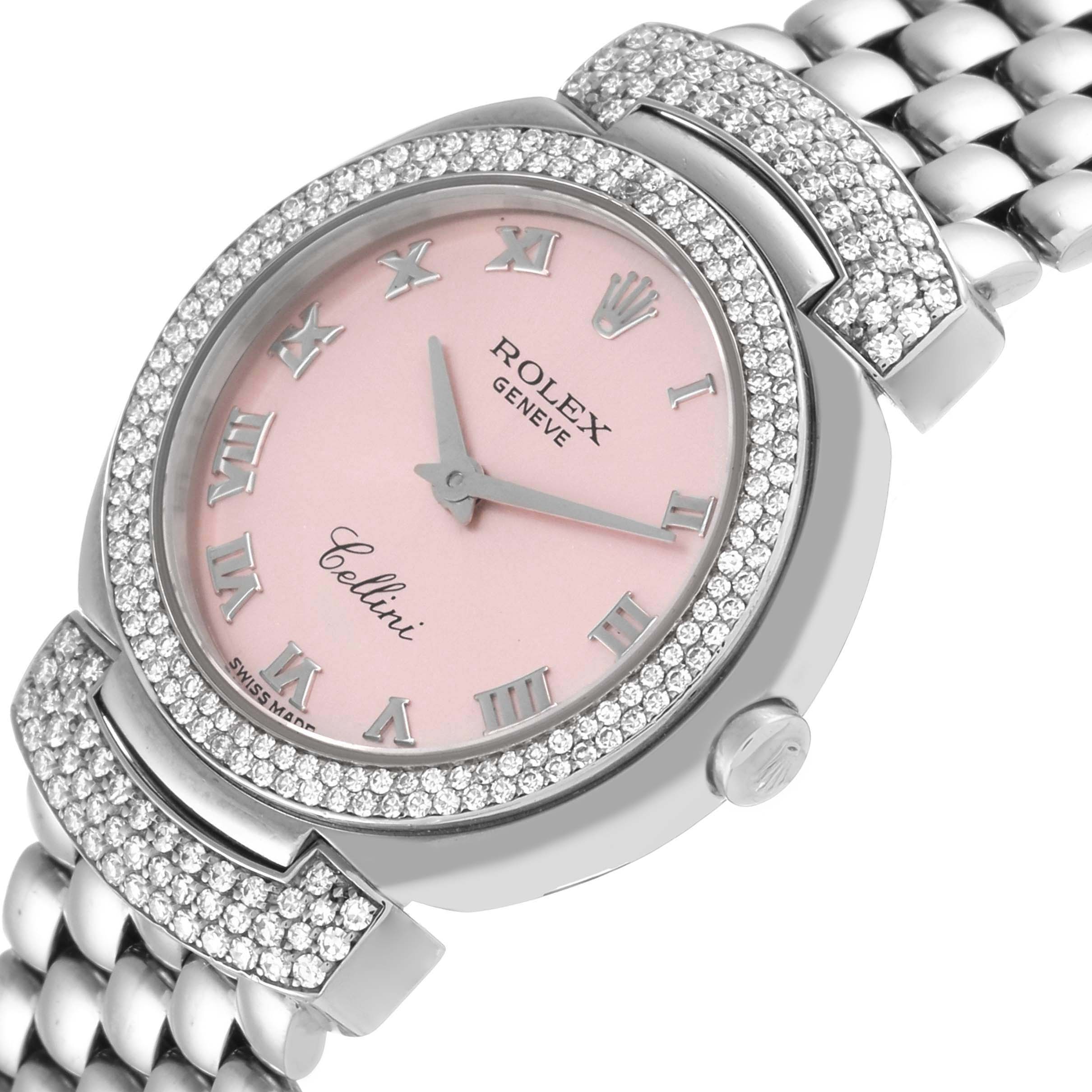 This image shows a close-up, angled view of the Rolex Cellini 6673 Women
s White Gold Pink Dial 6673 Women
s White Gold Pink Dial watch featuring a pink dial, diamond-studded bezel, and part of its bracelet.