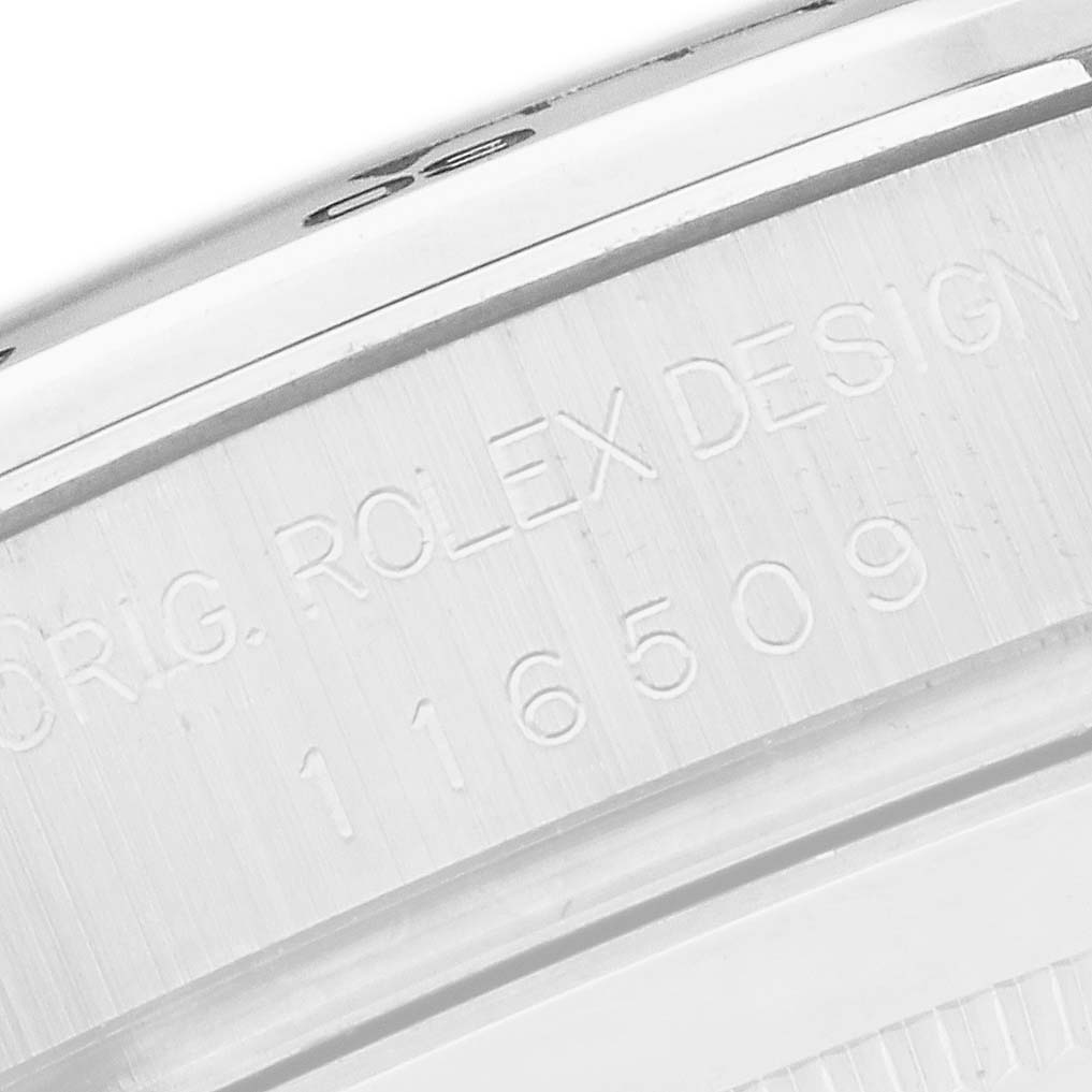 The image shows a close-up of the Rolex Daytona 116509 Men's White Gold Black Dial's case side, displaying engraved details.