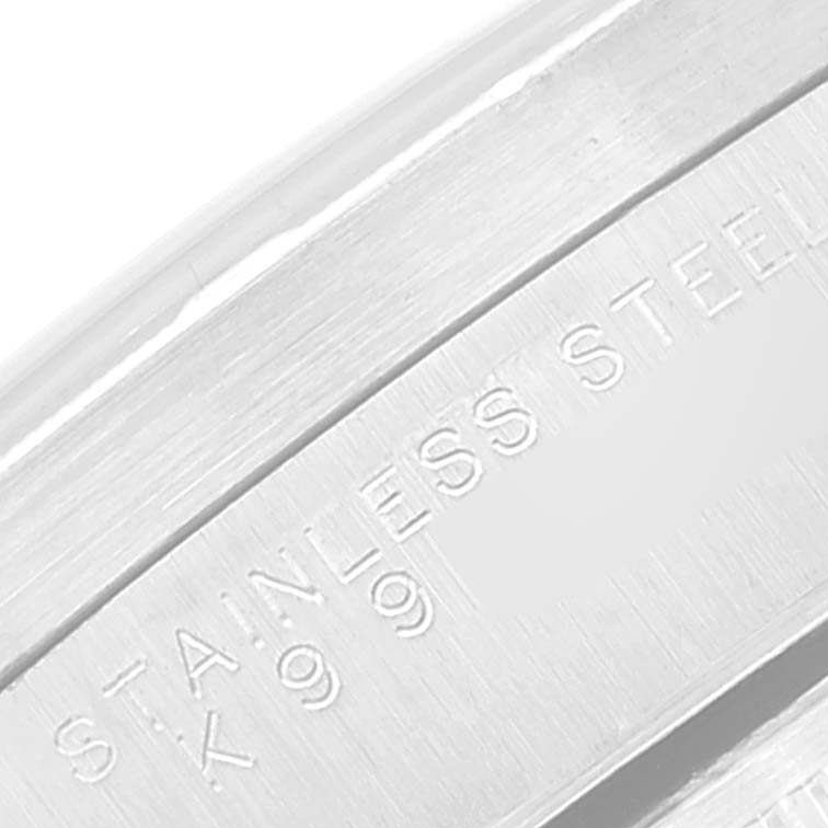 This close-up image shows the "STAINLESS STEEL 990" engraving on the case of a Rolex Date 15210 Men
s Stainless Steel Silver Dial 15210 Men
s Stainless Steel Silver Dial watch.