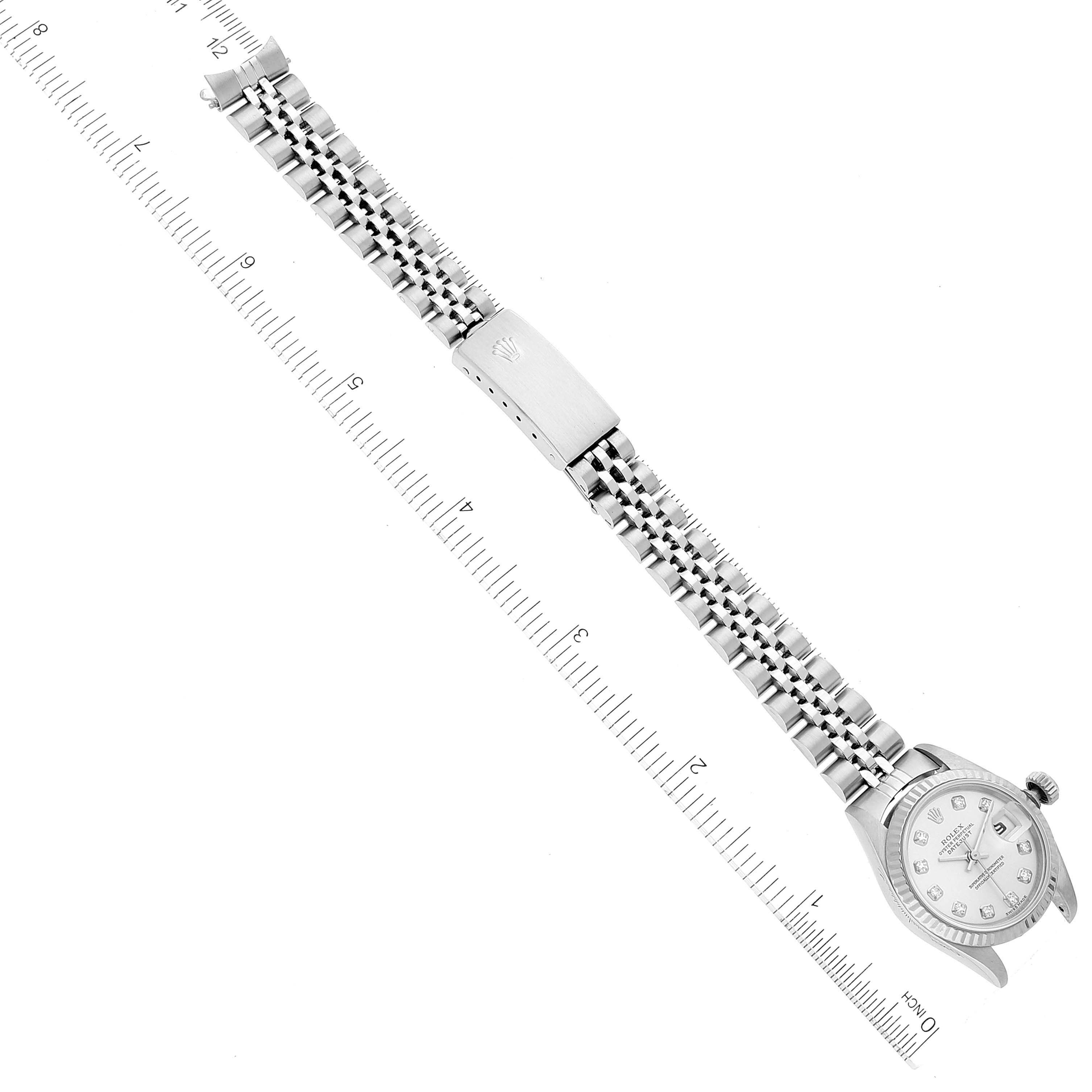 The image shows a top view of a Rolex Datejust 79174 Women's Stainless Steel Silver Dial 79174 Women's Stainless Steel Silver Dial watch, displaying the face, case, and bracelet fully extended with a ruler for scale.