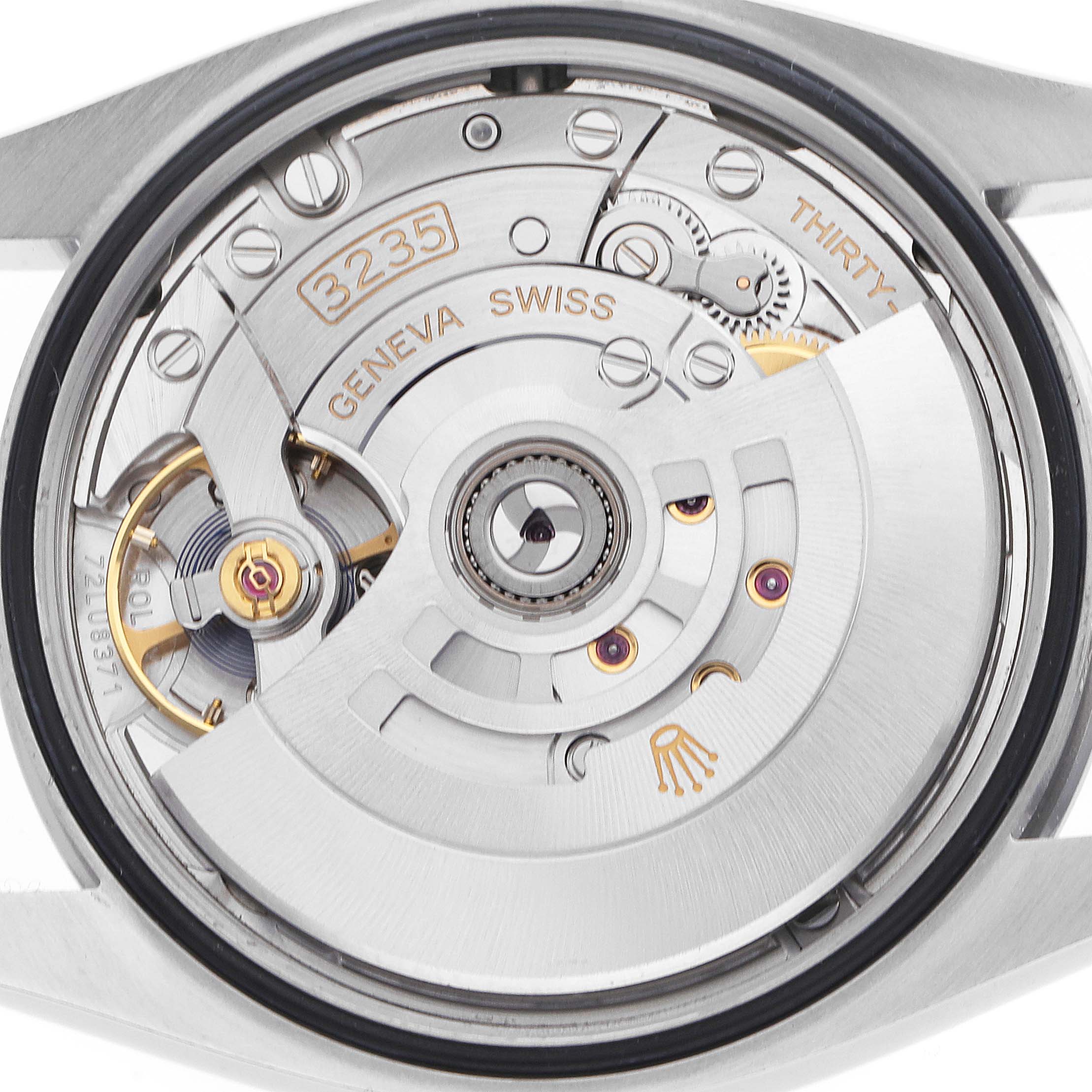 The image shows the movement of a Rolex Datejust 126200 Men's Stainless Steel Silver Dial watch from a rear angle, highlighting its intricate mechanical components.