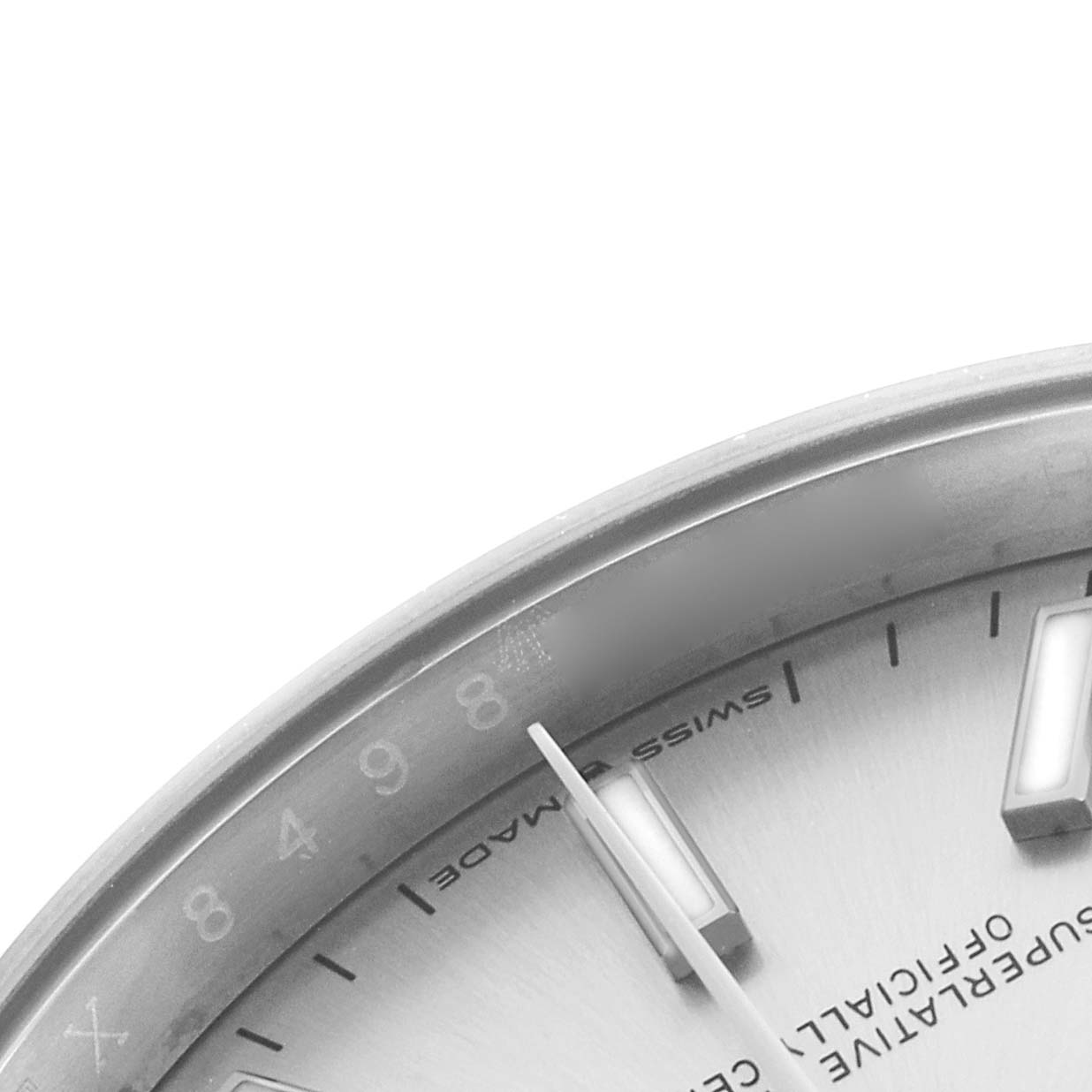 The image shows a close-up of the dial and markers of a Rolex Datejust 126200 Men's Stainless Steel Silver Dial watch, highlighting its details and textures.