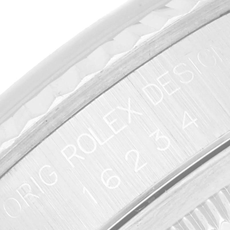 This image shows an extreme close-up of the engraving on the inner bezel of a Rolex Datejust 16234 Men's Stainless Steel Blue Dial 16234 Men's Stainless Steel Blue Dial watch.