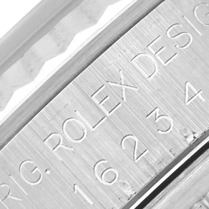 This image shows the engraved side of a Rolex Datejust 16234 Men's Stainless Steel Silver Dial 16234 Men's Stainless Steel Silver Dial watch case, highlighting the model's reference details.