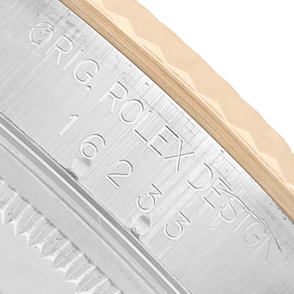 The image shows a close-up of the side of a Rolex Datejust 16233 Men's Steel and Gold (two tone) Champagne Dial, highlighting the engraved model number and bezel details.