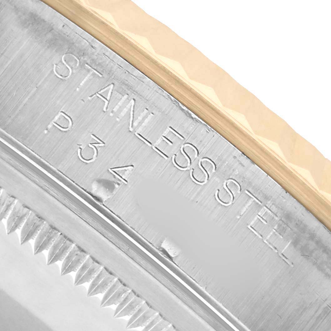 The image shows a close-up of the side of a Rolex Datejust 16233 Men's Steel and Gold (two tone) Champagne Dial, focusing on the stainless steel case and part of the fluted bezel.