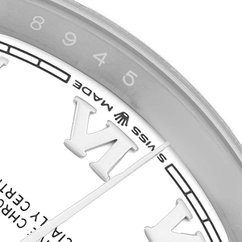The image shows a close-up of the Rolex Datejust 126200 Men's Stainless Steel White Dial dial, highlighting the edge with Roman numerals and part of the bezel.