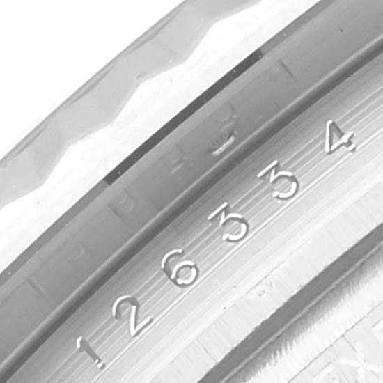 This close-up image shows the fluted bezel and part of the rehaut with serial numbers on a Rolex Datejust 41 126334 Men
s Stainless Steel Blue Dial 126334 Men
s Stainless Steel Blue Dial model.