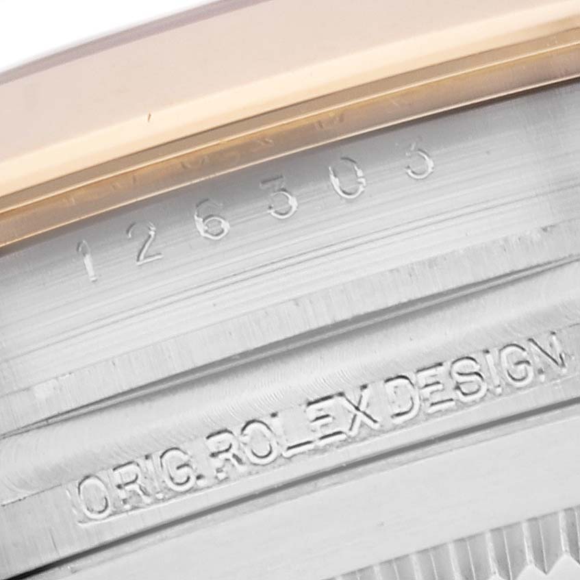This close-up image shows the engraved reference number and part of the bezel of a Rolex Datejust 41 126303 Men's Steel and Gold (two tone) White Dial 126303 Men's Steel and Gold (two tone) White Dial.