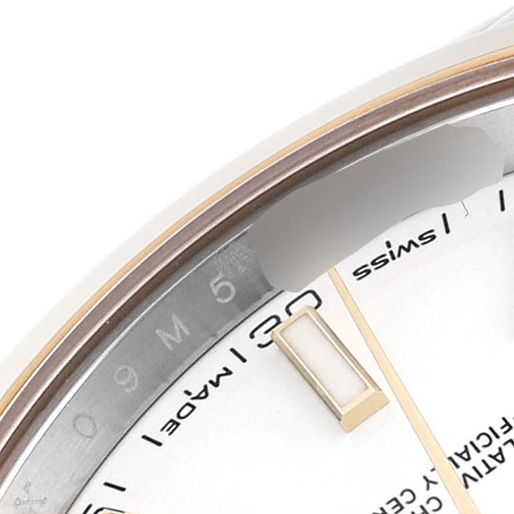 The image shows a close-up view of the dial and part of the bezel on a Rolex Datejust 41 126303 Men's Steel and Gold (two tone) White Dial 126303 Men's Steel and Gold (two tone) White Dial.
