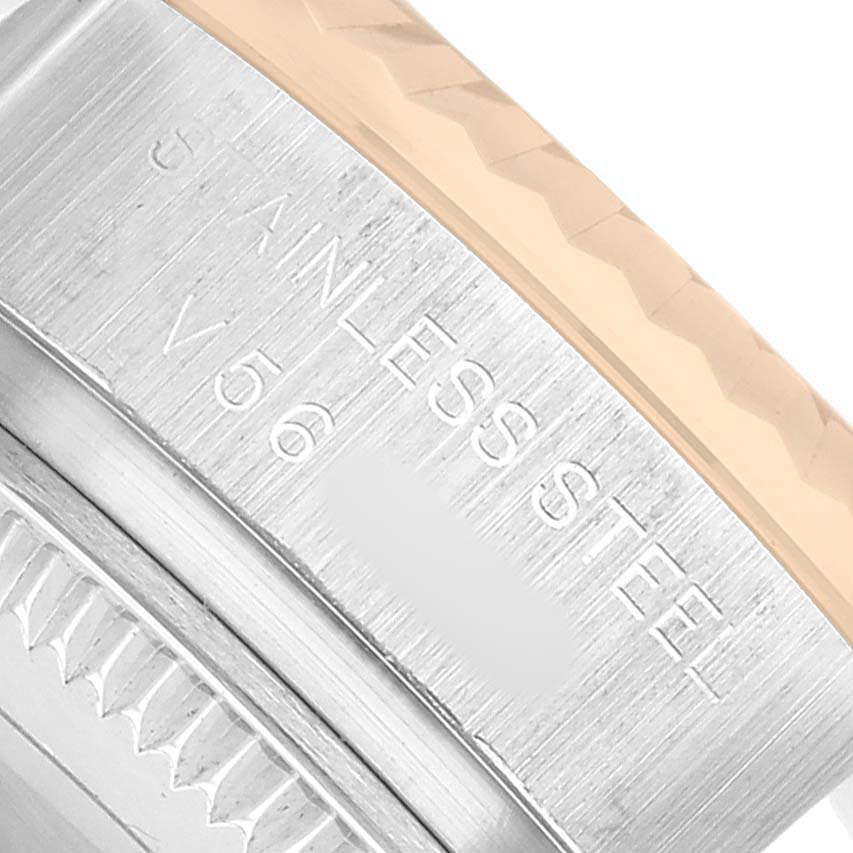 The image shows a close-up of the side of a Rolex Datejust 179173 Men's Steel and Gold (two tone) Silver Dial watch case, highlighting the metal inscription and fluted bezel.