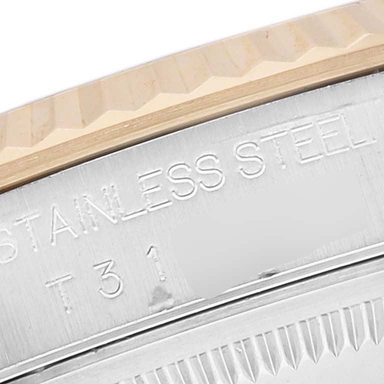 The image shows a close-up of the stainless steel side and fluted bezel of a Rolex Datejust 16233 Men's Steel and Gold (two tone) White Dial 16233 Men's Steel and Gold (two tone) White Dial watch.